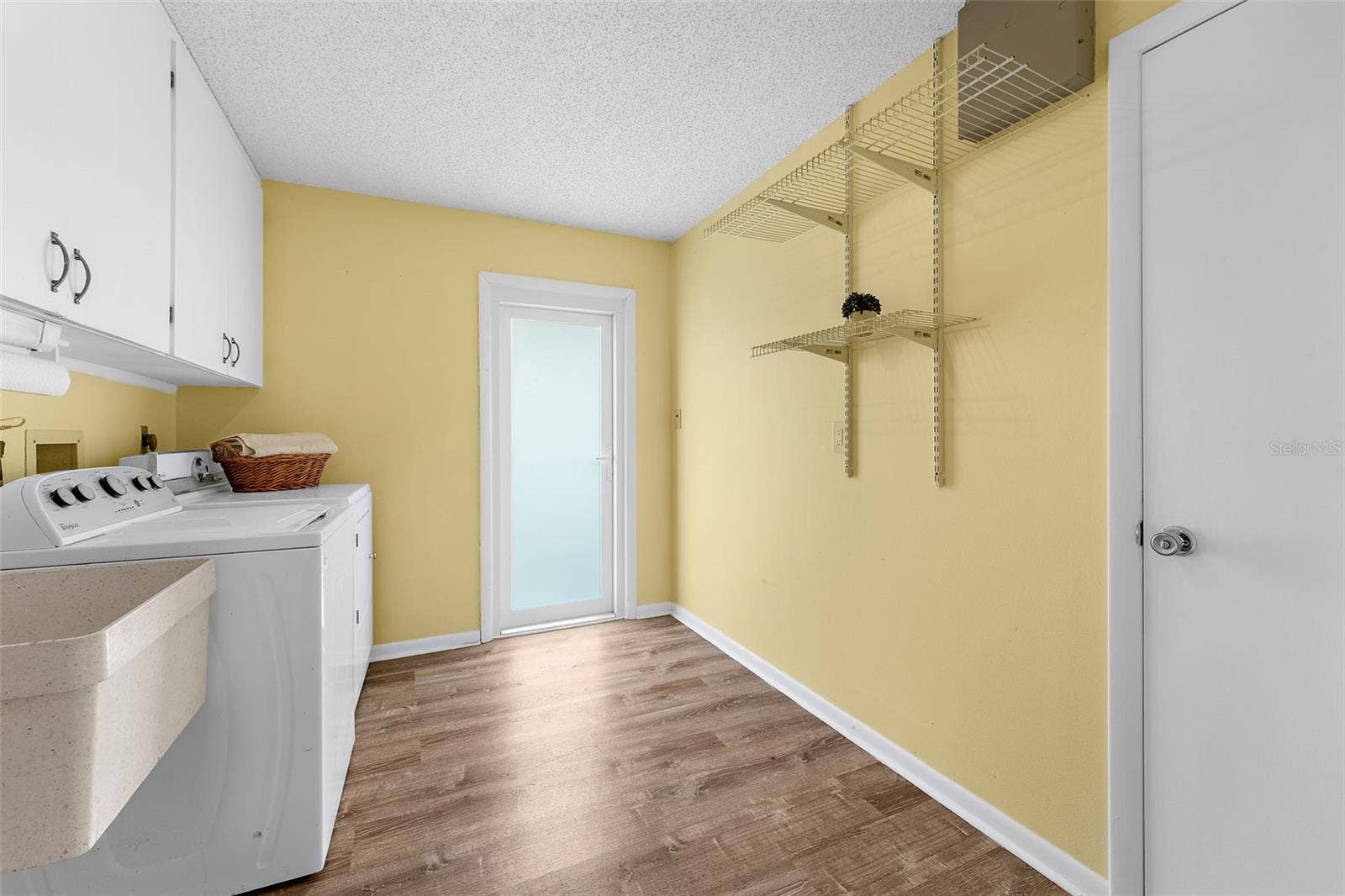 Separate utility room with access to garage and separate door to the side of the home.