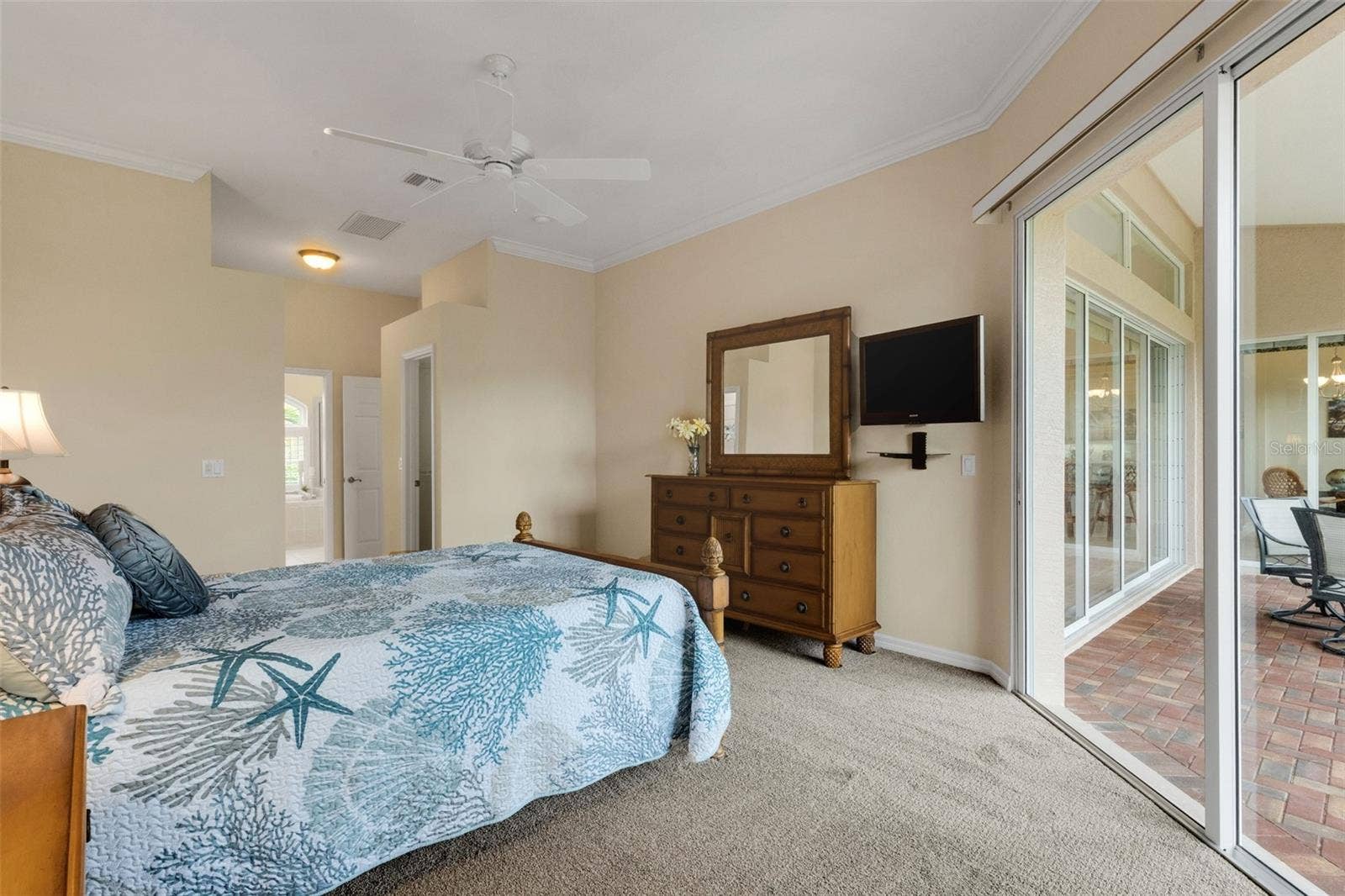 Primary bedroom with sliding doors to screened lanai