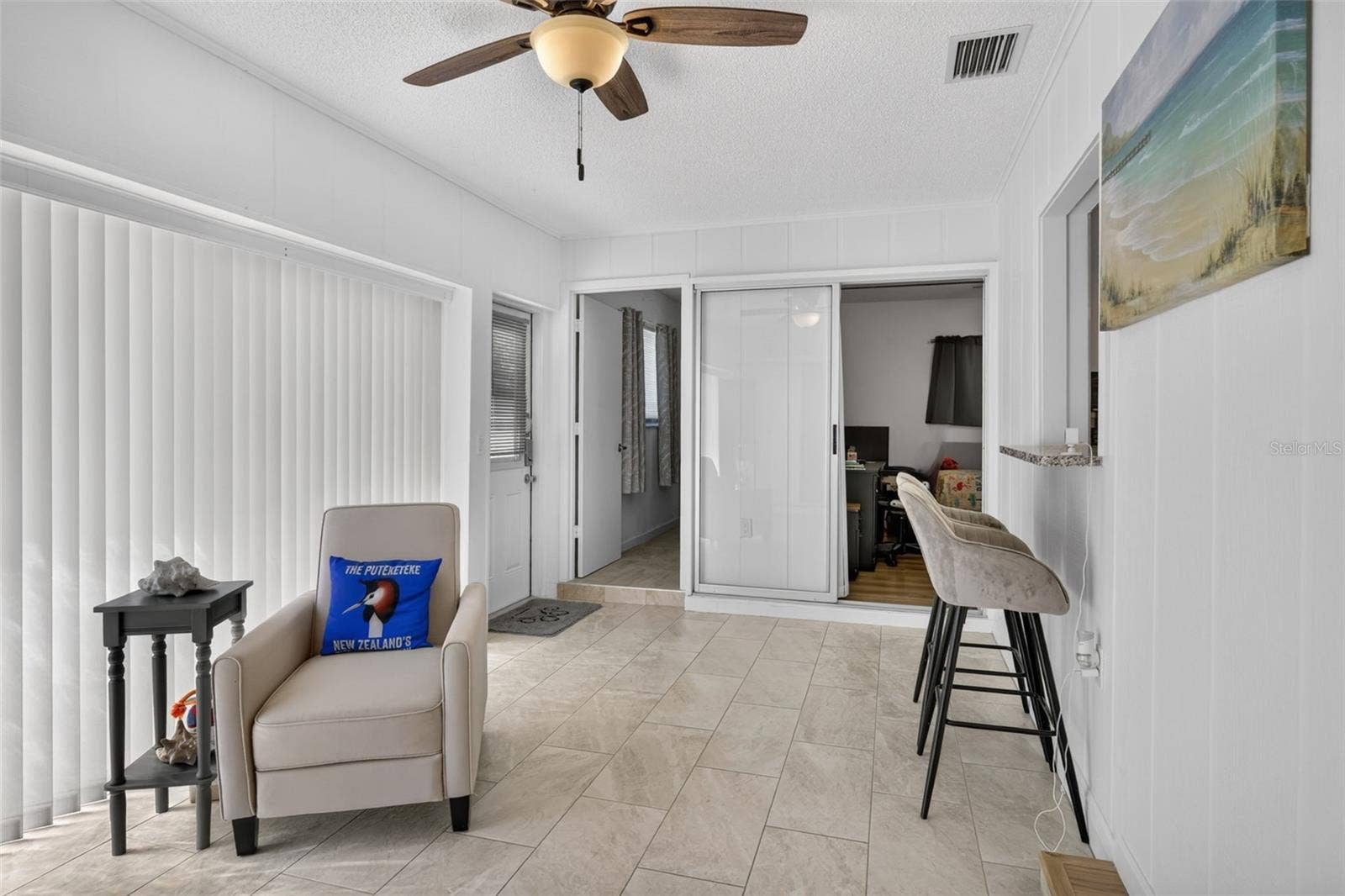 82 CIRCLEWOOD DRIVE, #A3-4, Venice, FL 34293 Family room with bar stools at a counter that looks through to kitchen