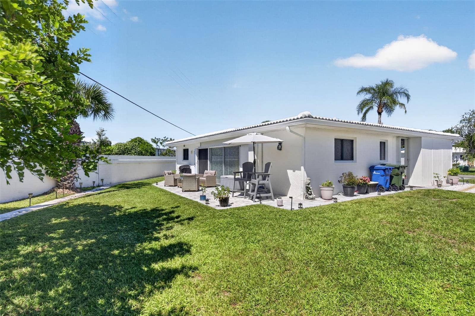 82 CIRCLEWOOD DRIVE, #A3-4, Venice, FL 34293 View of backyard and patio