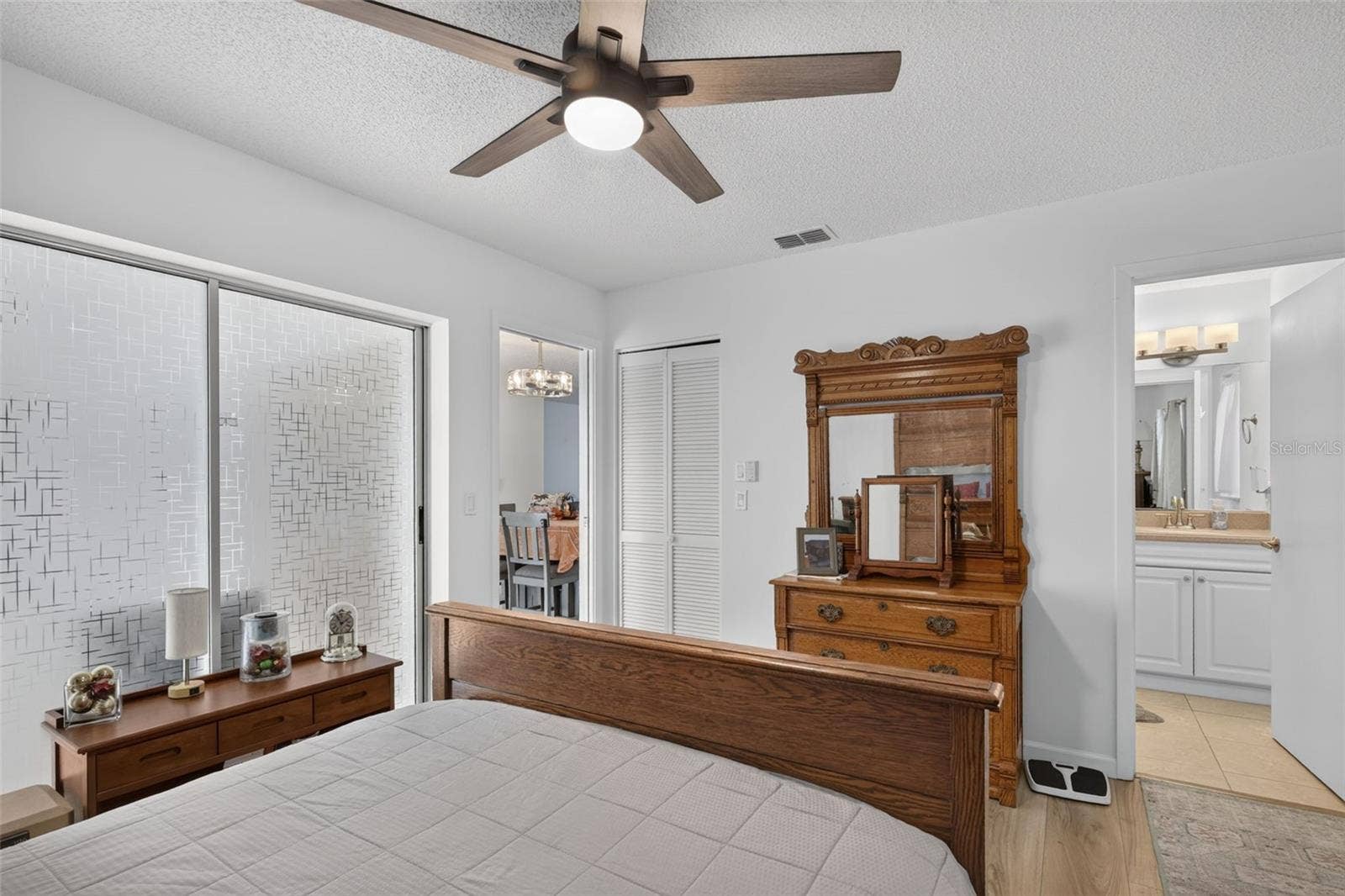 82 CIRCLEWOOD DRIVE, #A3-4, Venice, FL 34293 Primary bedroom showing closet and en suite bathroom