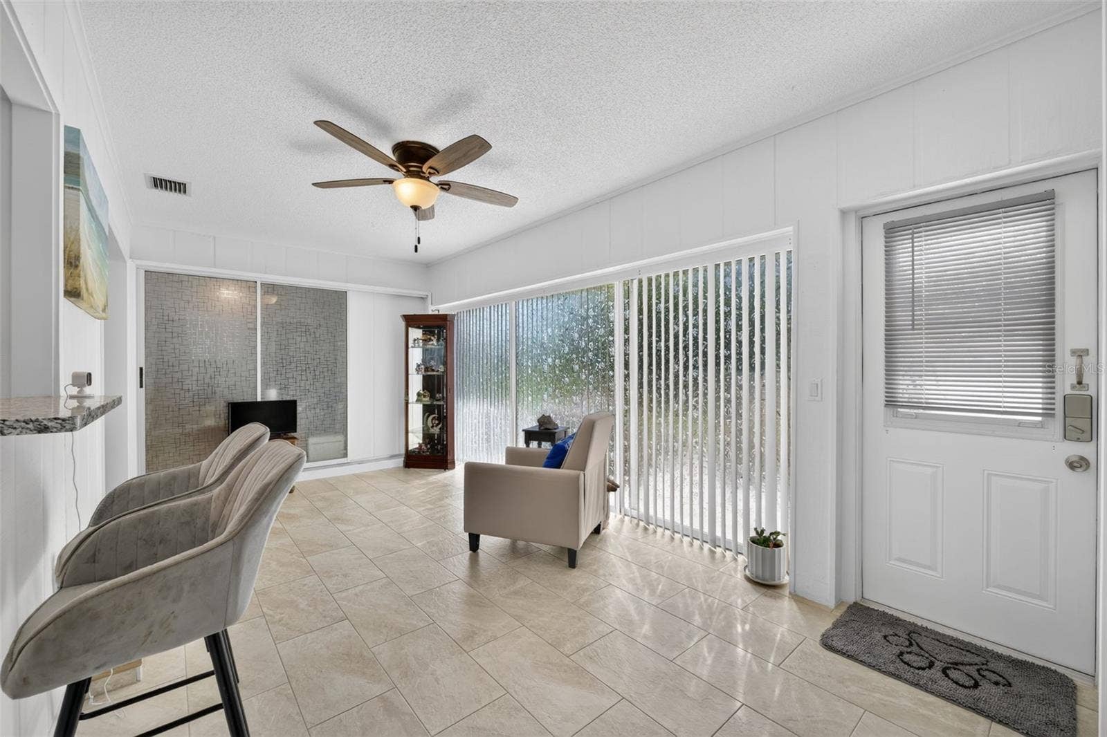 82 CIRCLEWOOD DRIVE, #A3-4, Venice, FL 34293 Family room with slider doors and door leading to patio