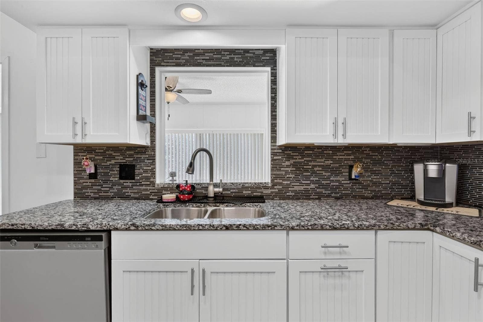 82 CIRCLEWOOD DRIVE, #A3-4, Venice, FL 34293 Kitchen sink with opening looking out to family room