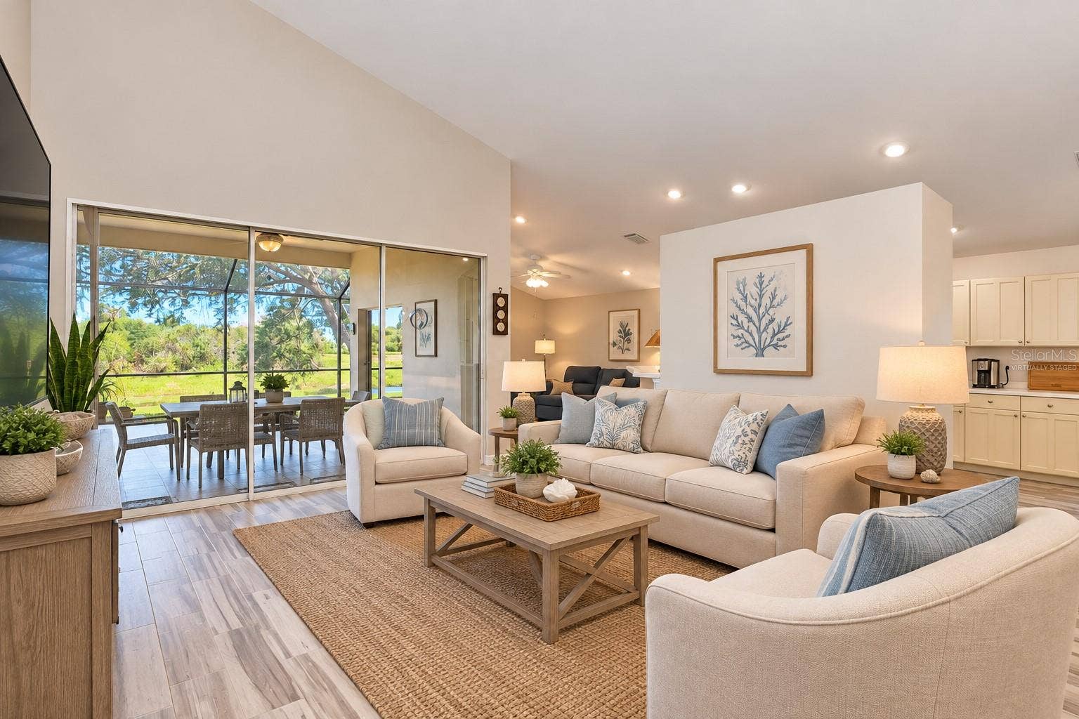 5113 FLAGSTONE DRIVE, Sarasota, FL 34238 Virtually Staged Living room with vaulted 13' ceiling.