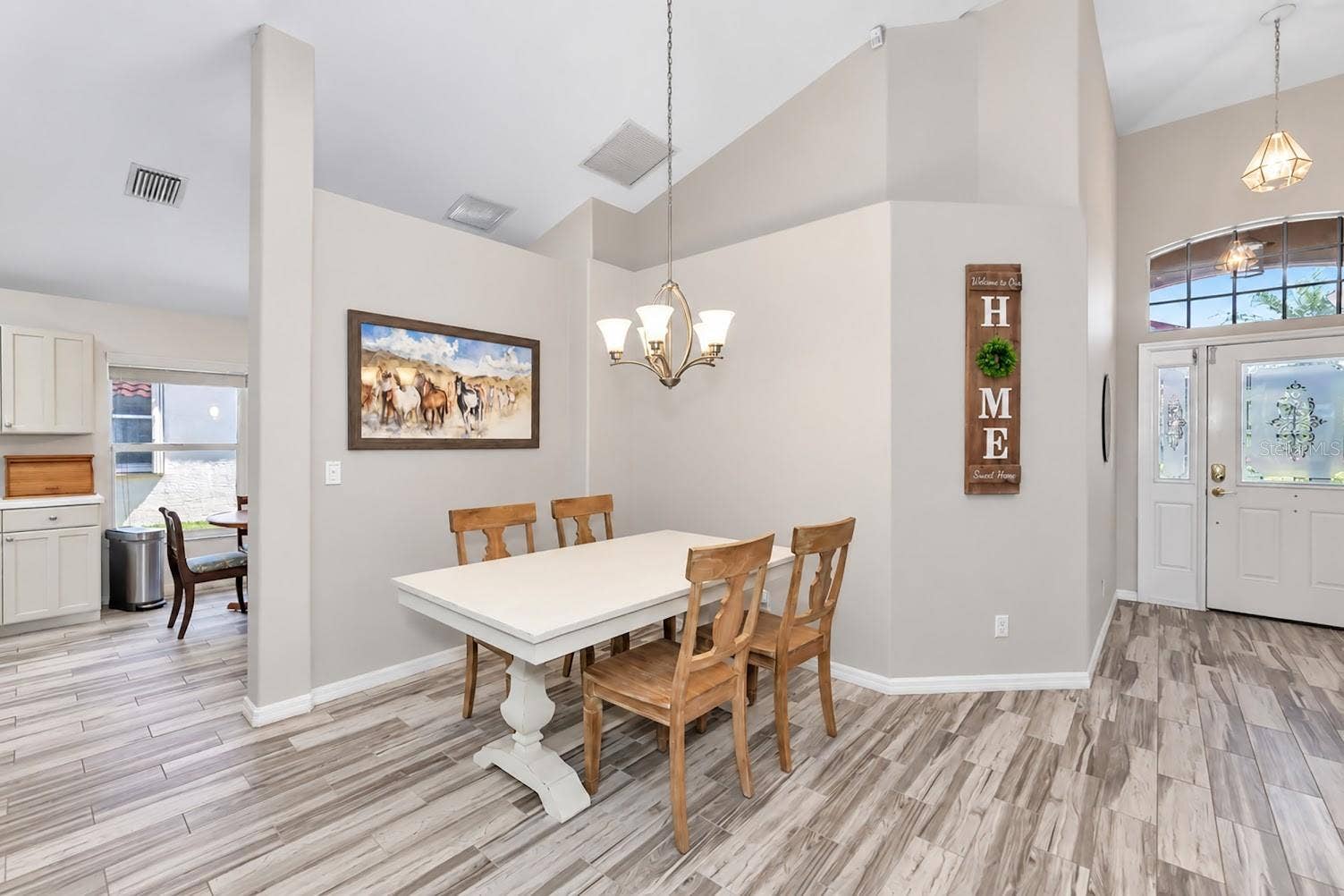 5113 FLAGSTONE DRIVE, Sarasota, FL 34238 Plank tile flooring living areas and bedrooms.