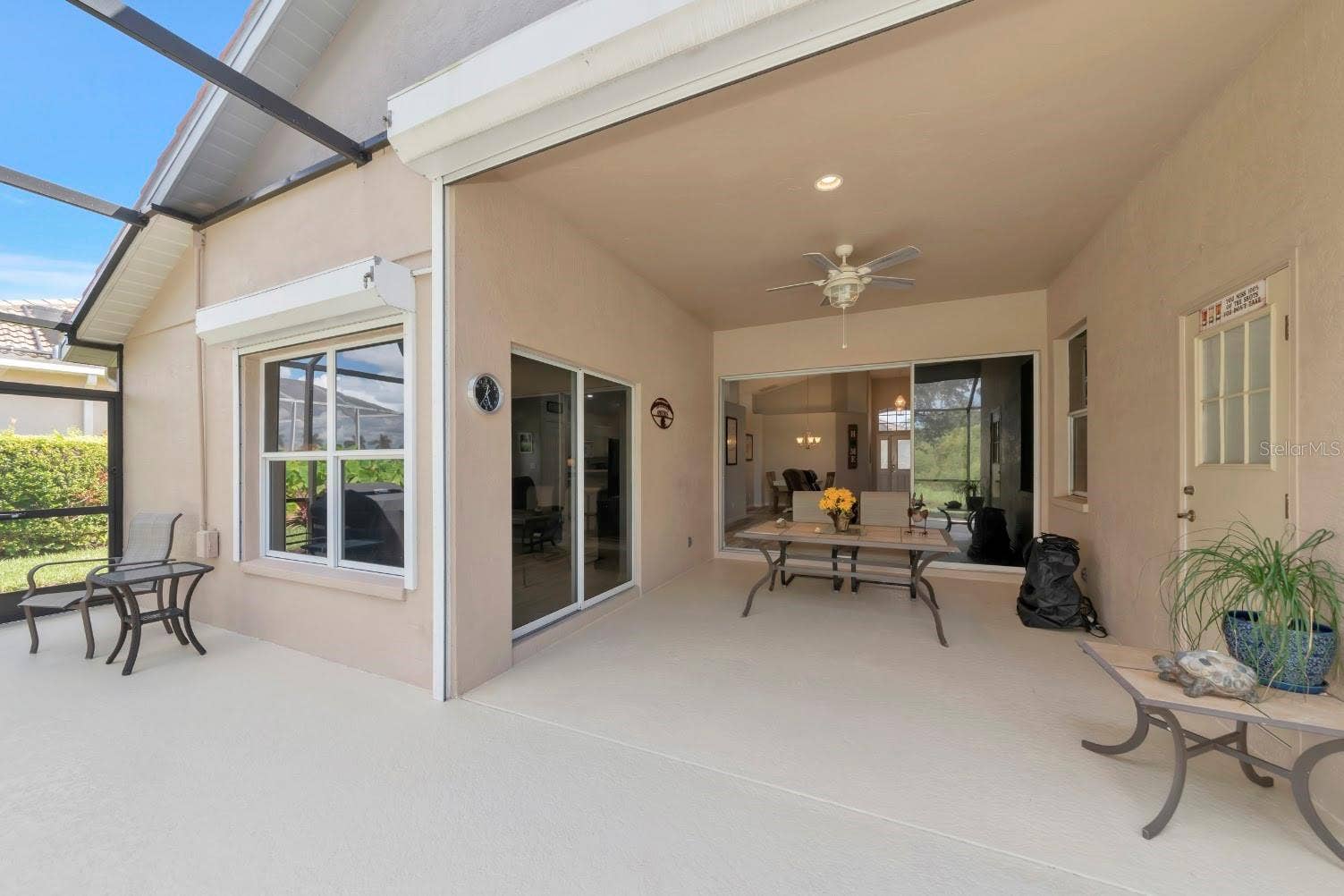 5113 FLAGSTONE DRIVE, Sarasota, FL 34238 Roll down storm shutters on deep covered lanai.