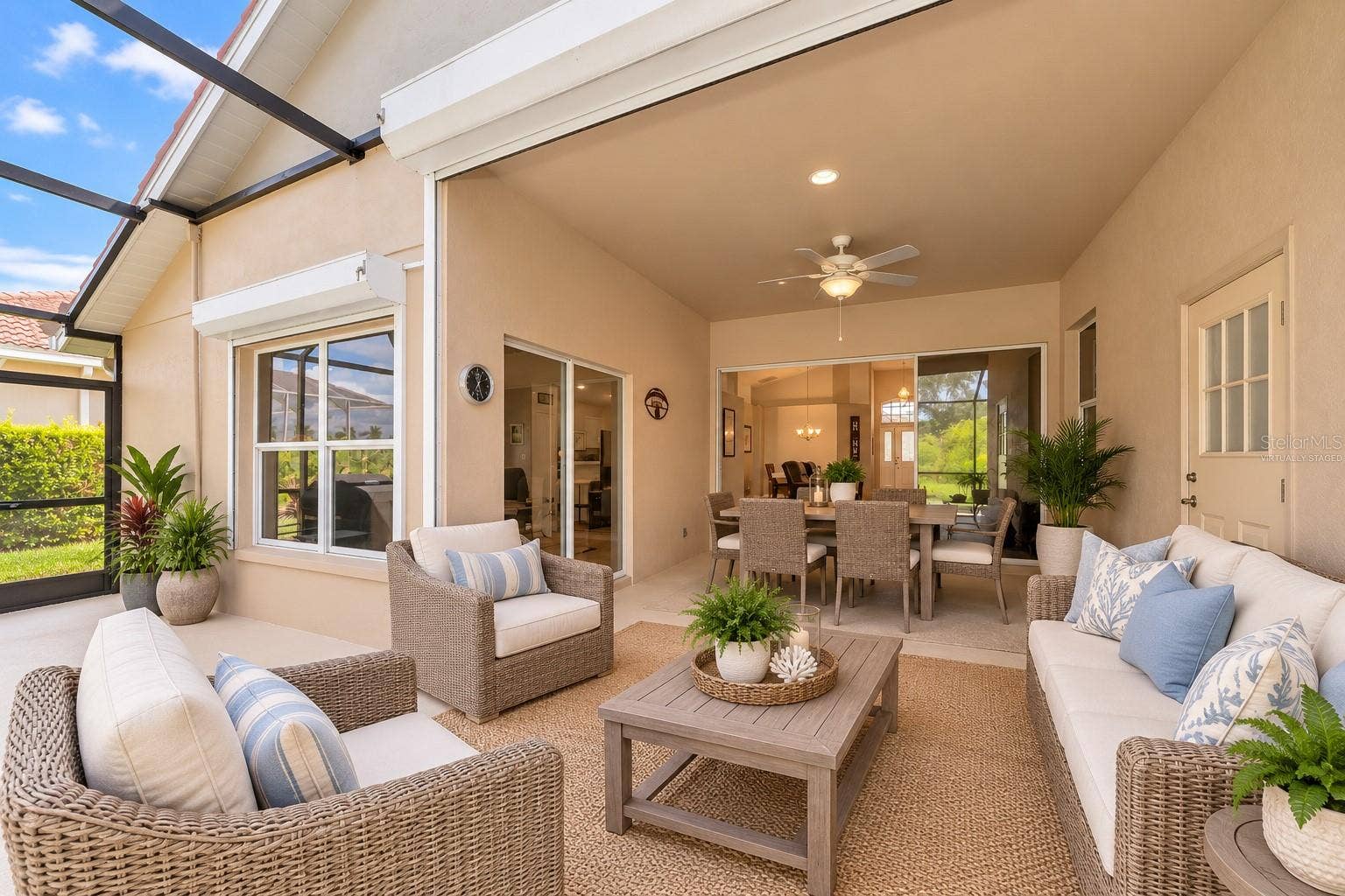 5113 FLAGSTONE DRIVE, Sarasota, FL 34238 Virtually Staged Roll down storm shutters on deep covered lanai.