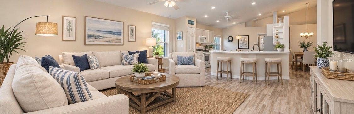 5113 FLAGSTONE DRIVE, Sarasota, FL 34238 Virtually Staged Family room open to kitchen and kitchen cafe.