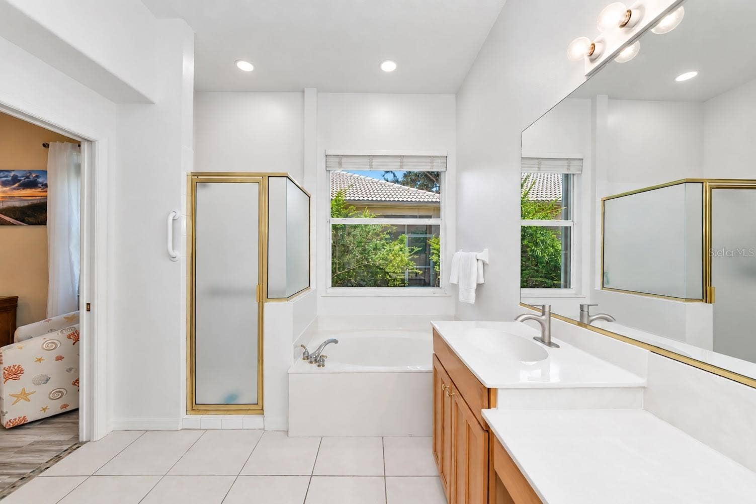 5113 FLAGSTONE DRIVE, Sarasota, FL 34238 Primary suite shower and separate tub.