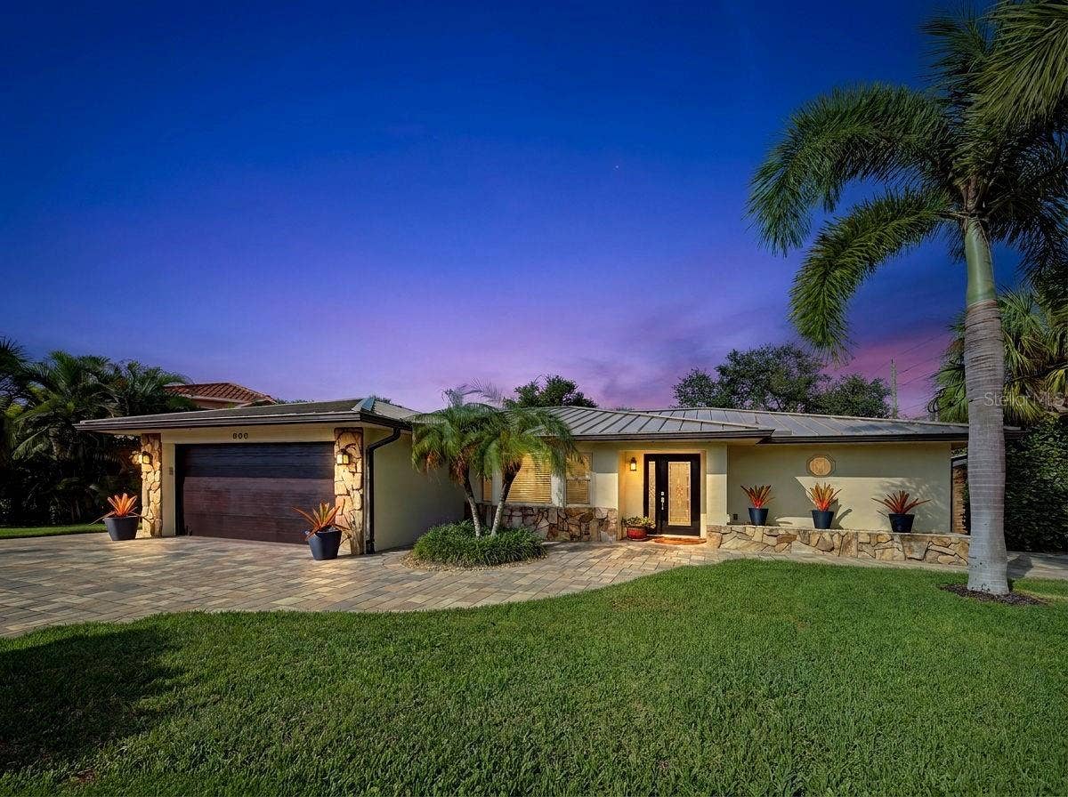 800 OSPREY STREET, Venice, FL 34285 Front of home has paver driveway and beautifully landscaped.