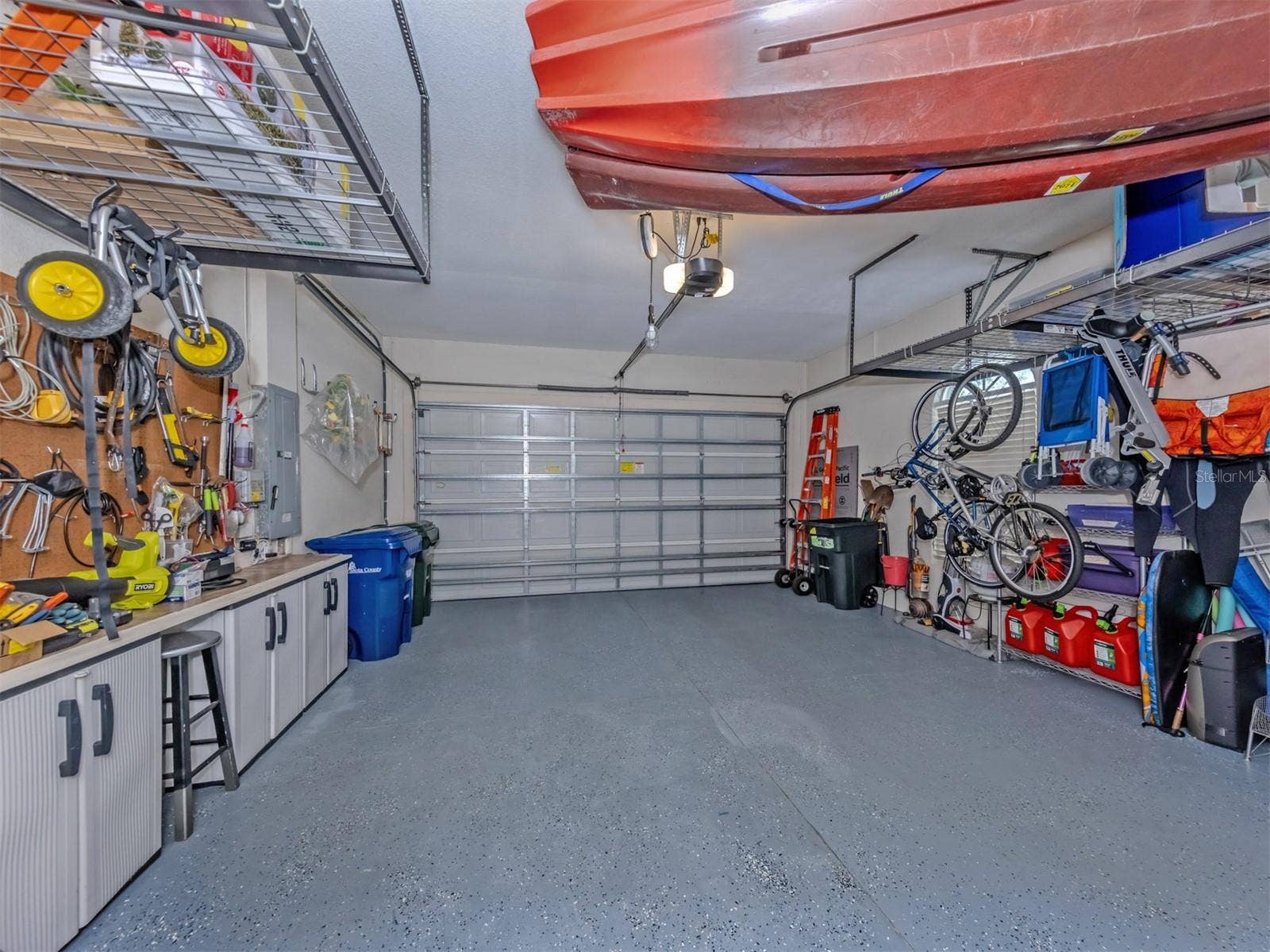 Not your ordinary garage! This oversized two-car garage is a standout, featuring sleek epoxy-coated flooring, impressive ceiling-mounted storage cubes that maximize space while keeping everything neatly organized, and a dedicated generator connection with a manual transfer switch conveniently located on the electrical panel for added peace of mind. Roomy, practical, and packed with smart features, this is a garage you'll be excited to show off!