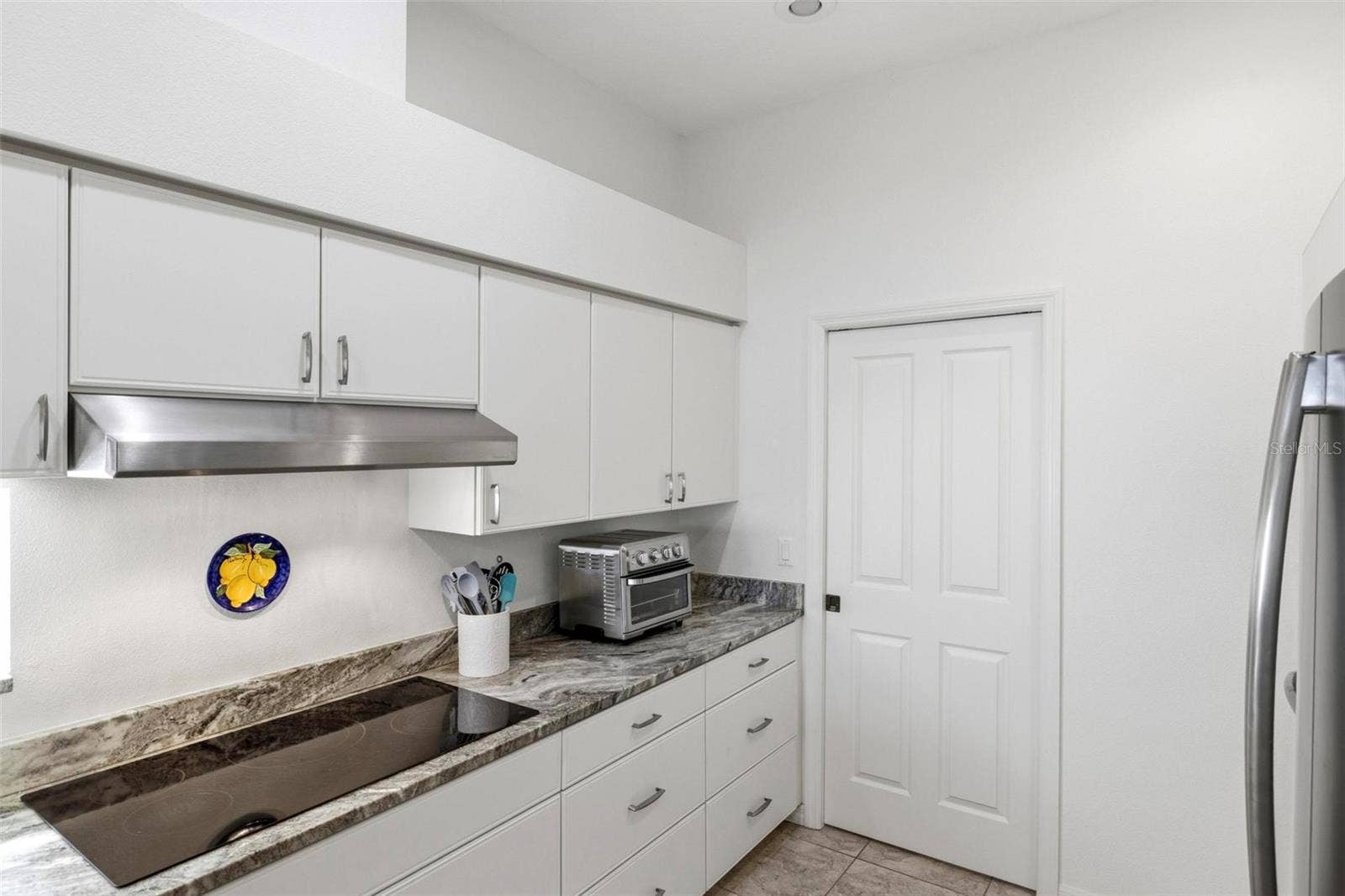 687 LAKESCENE DRIVE, Venice, FL 34293 Kitchen with pocket door to laundry room