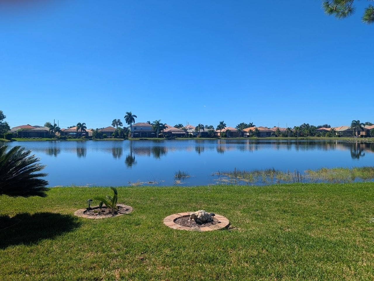 2216 WEAVER BIRD LANE, Venice, FL 34292 Daytime views of the lake from Lanai & Primary Bedroom