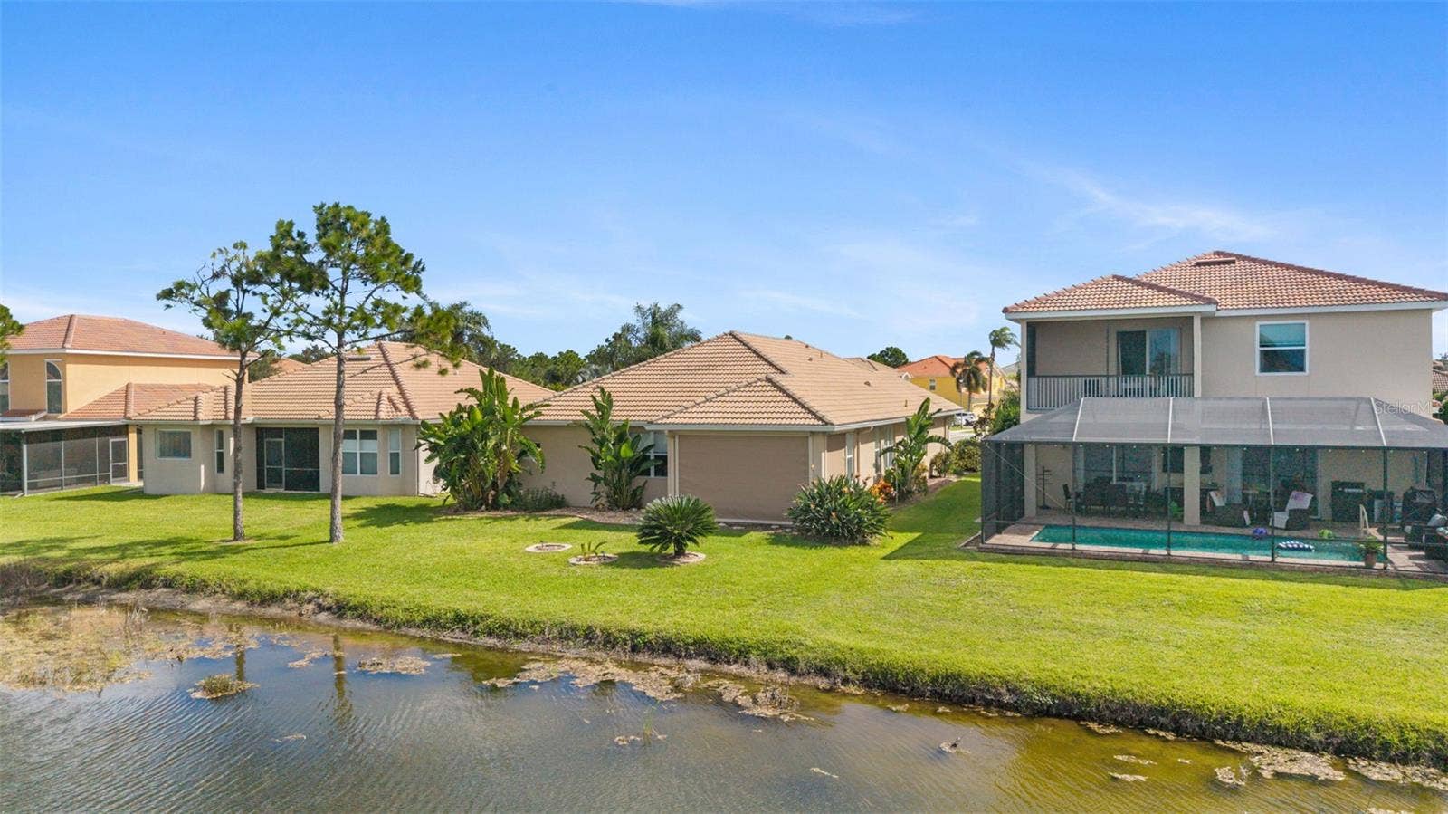 2216 WEAVER BIRD LANE, Venice, FL 34292 Back of home with Bird of Paradise Plants