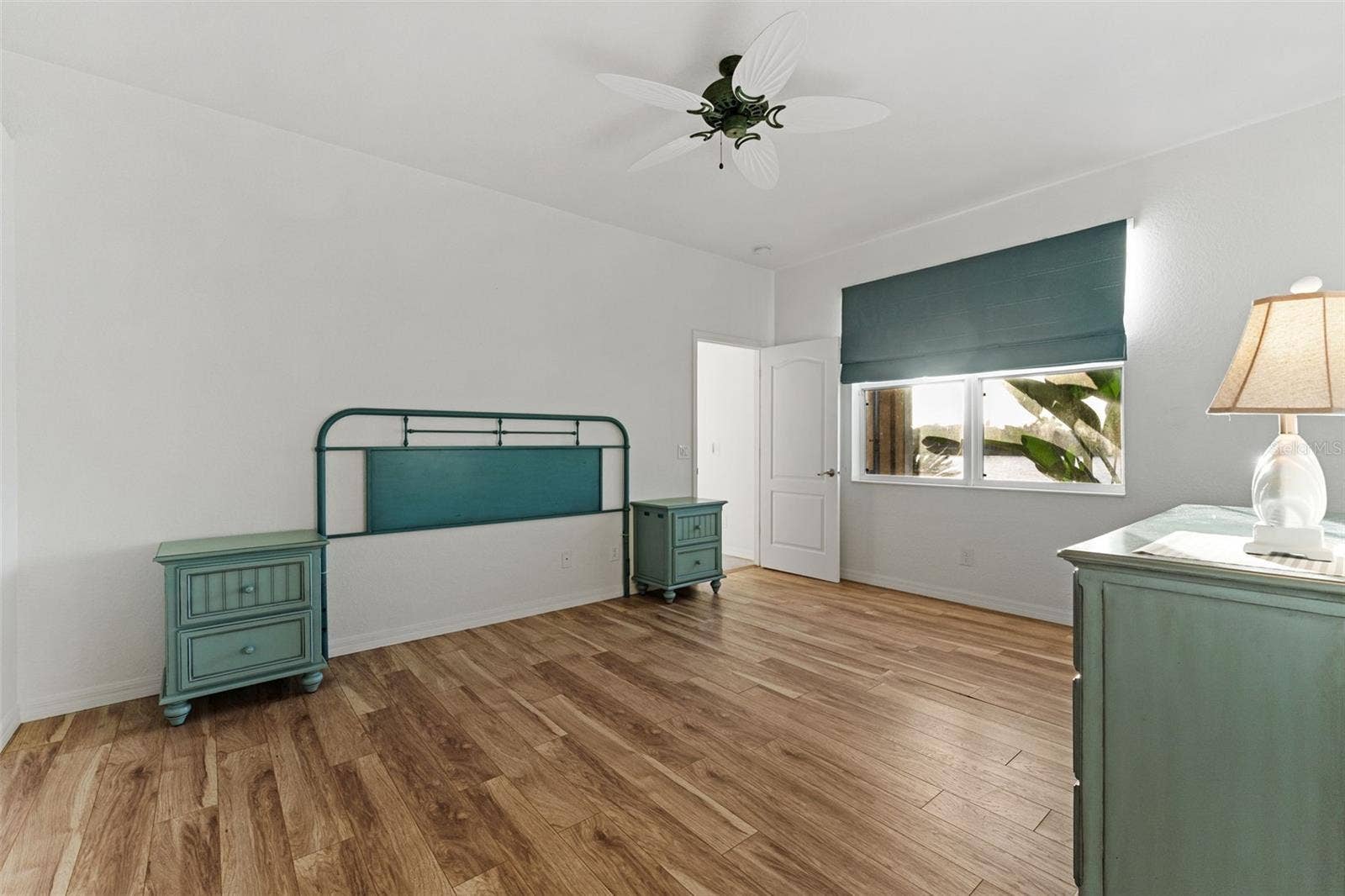 2216 WEAVER BIRD LANE, Venice, FL 34292 Another view of the spacious bedroom featuring warm wood flooring & plenty of room for additional or different furnishings