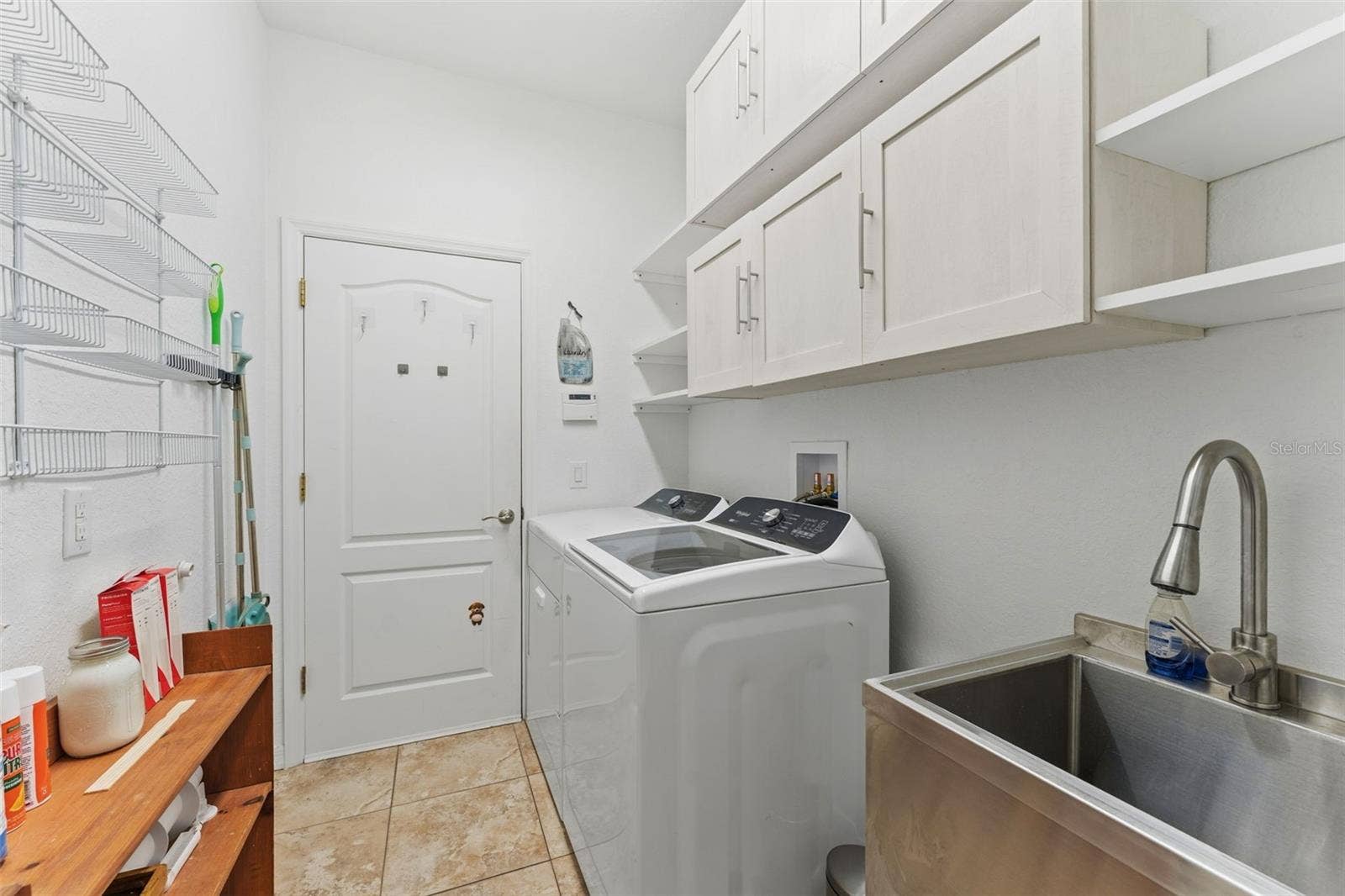 2216 WEAVER BIRD LANE, Venice, FL 34292 Laundry Room with full size washer/dryer and stainless steel utility sink as well as cupboard and shelf space