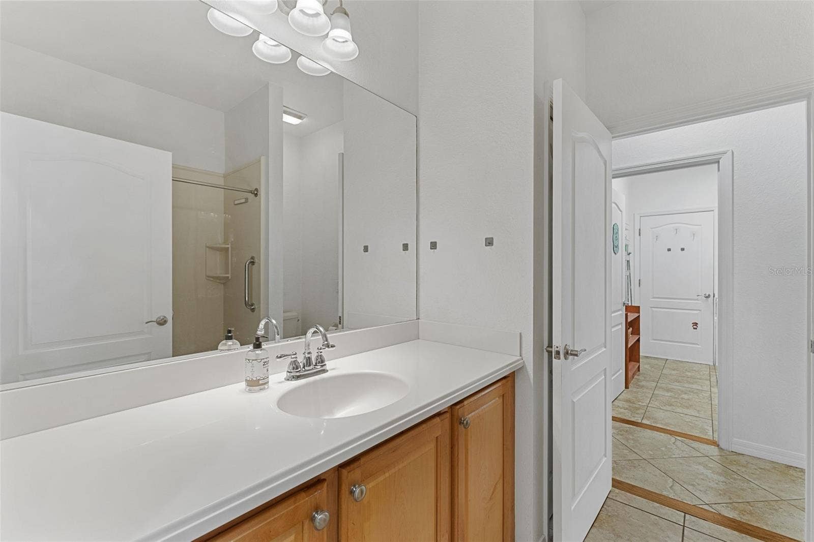2216 WEAVER BIRD LANE, Venice, FL 34292 Single vanity with lots of counterspace; Doorways on each side of bathroom