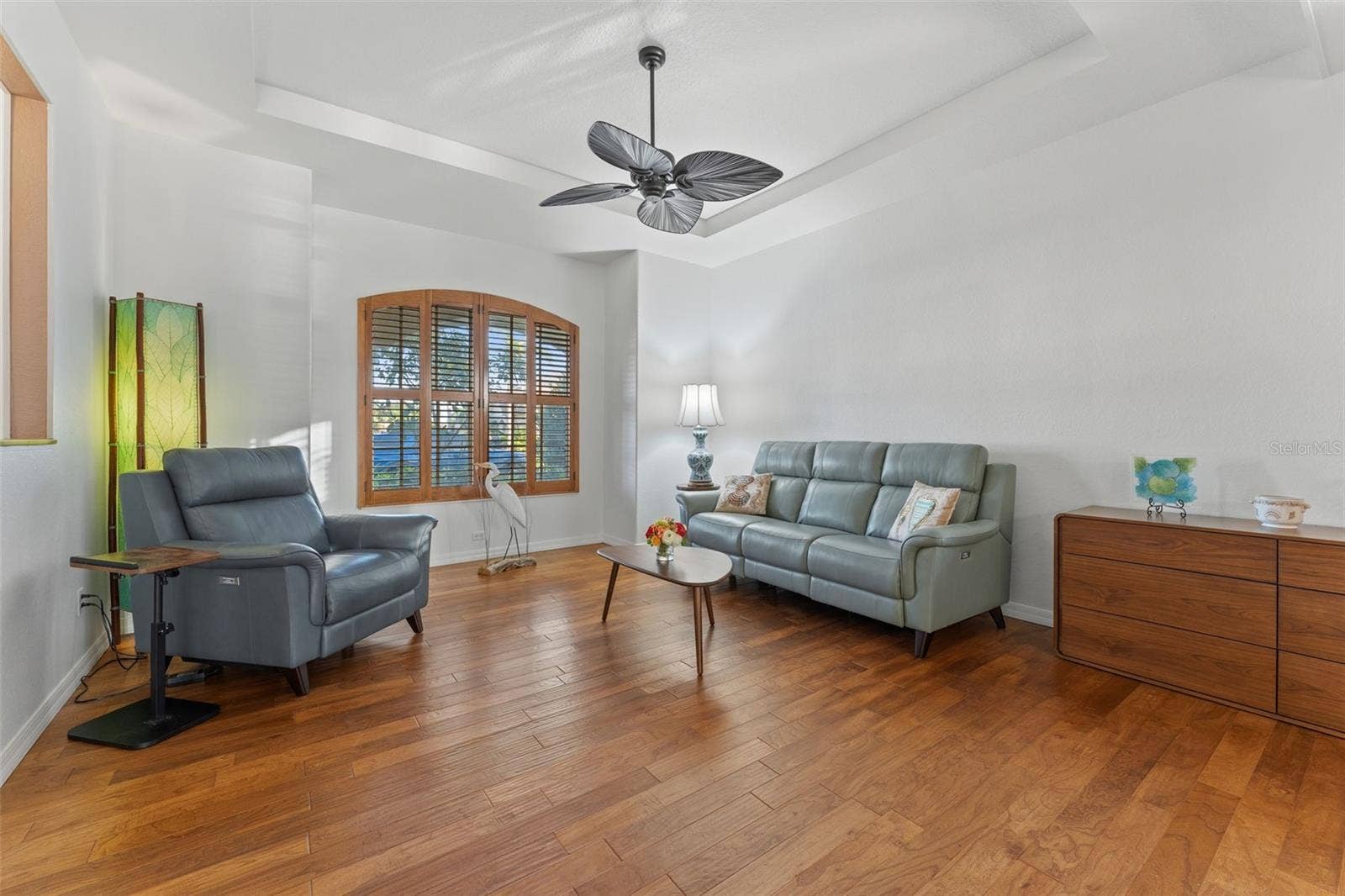 2216 WEAVER BIRD LANE, Venice, FL 34292 Living room with freshly painted wall and contrasting Plantation Shutters