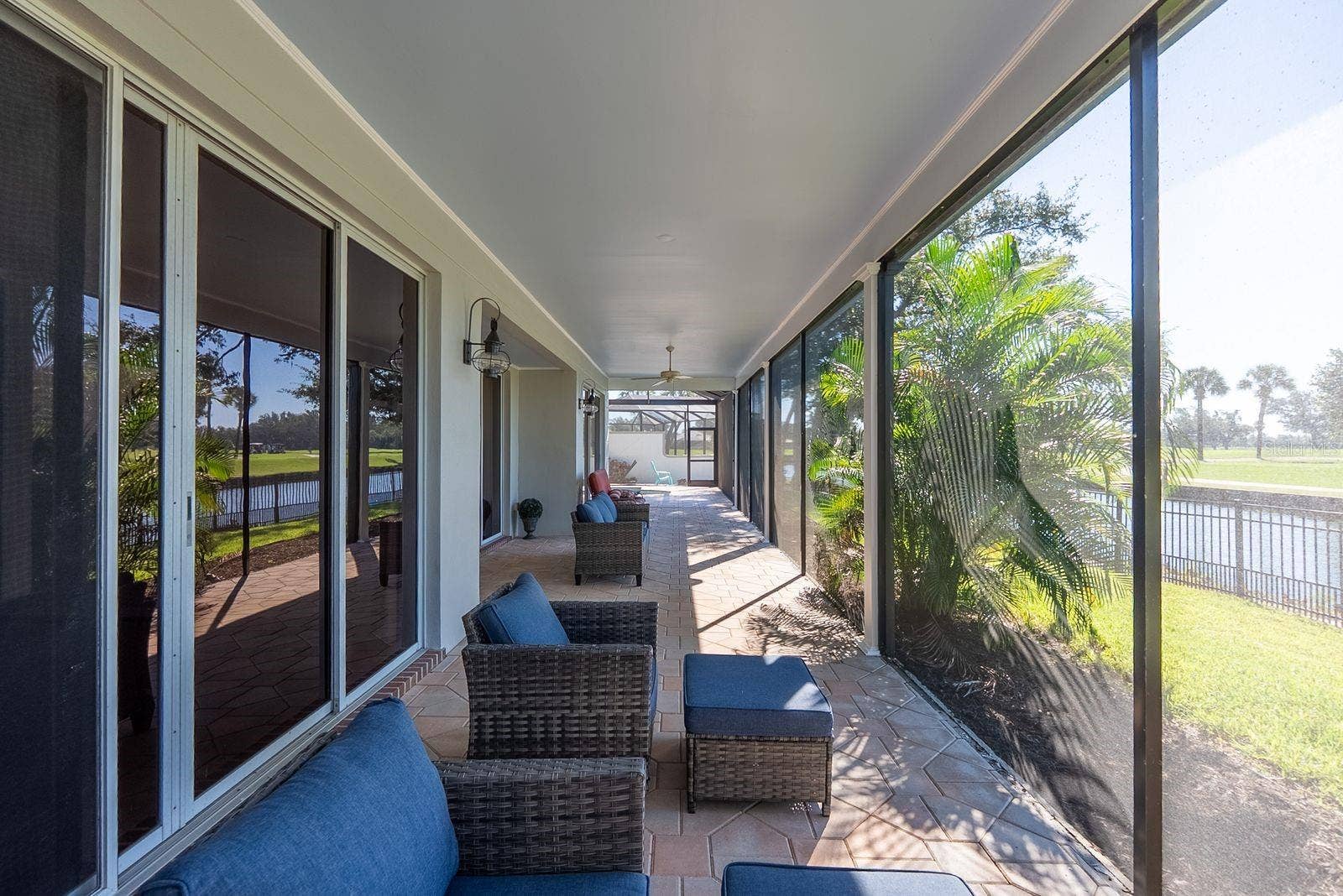 71 CAYMAN ISLES BOULEVARD, Englewood, FL 34223 back covered patio just outside primary bedroom door