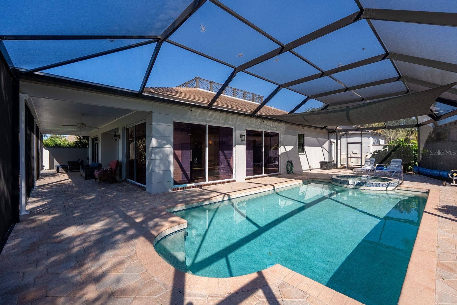 71 CAYMAN ISLES BOULEVARD, Englewood, FL 34223 Pool area patio on side wraps around to back patio