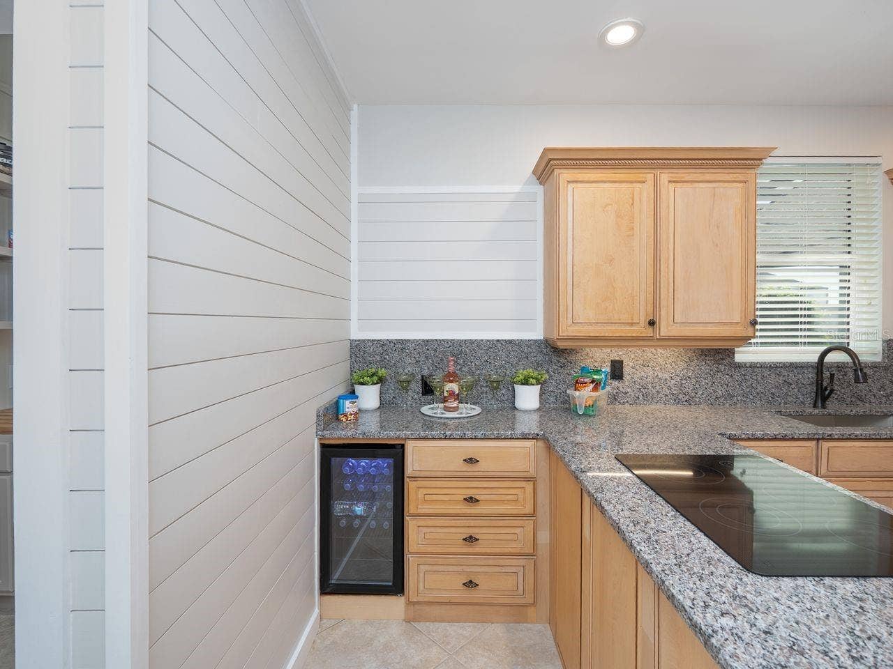 71 CAYMAN ISLES BOULEVARD, Englewood, FL 34223 Wine frig in kitchen with pretty ship lap wall accent