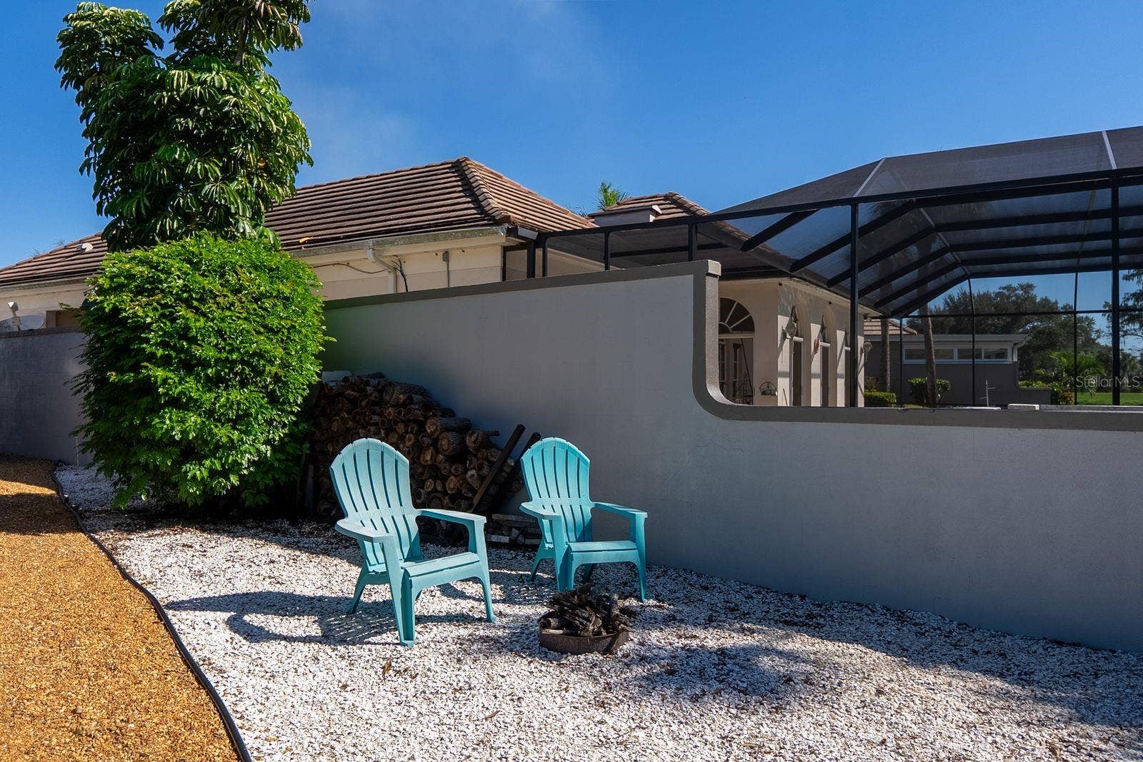71 CAYMAN ISLES BOULEVARD, Englewood, FL 34223 fire pit on side of house