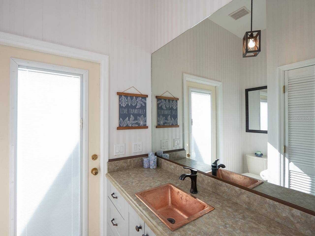 71 CAYMAN ISLES BOULEVARD, Englewood, FL 34223 1/2 bath adjacent to laundry room with door out to pool area