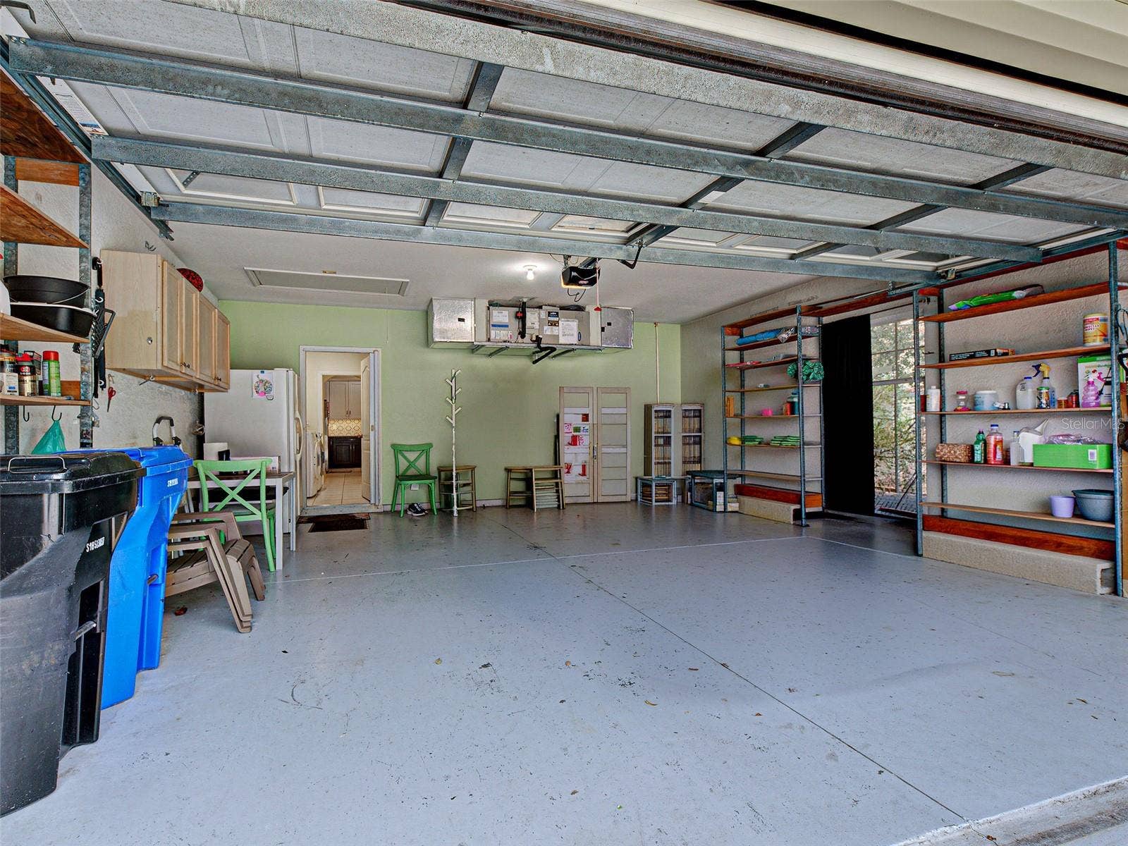The large two-car garage has room for cabinets, a refrigerator and shelving