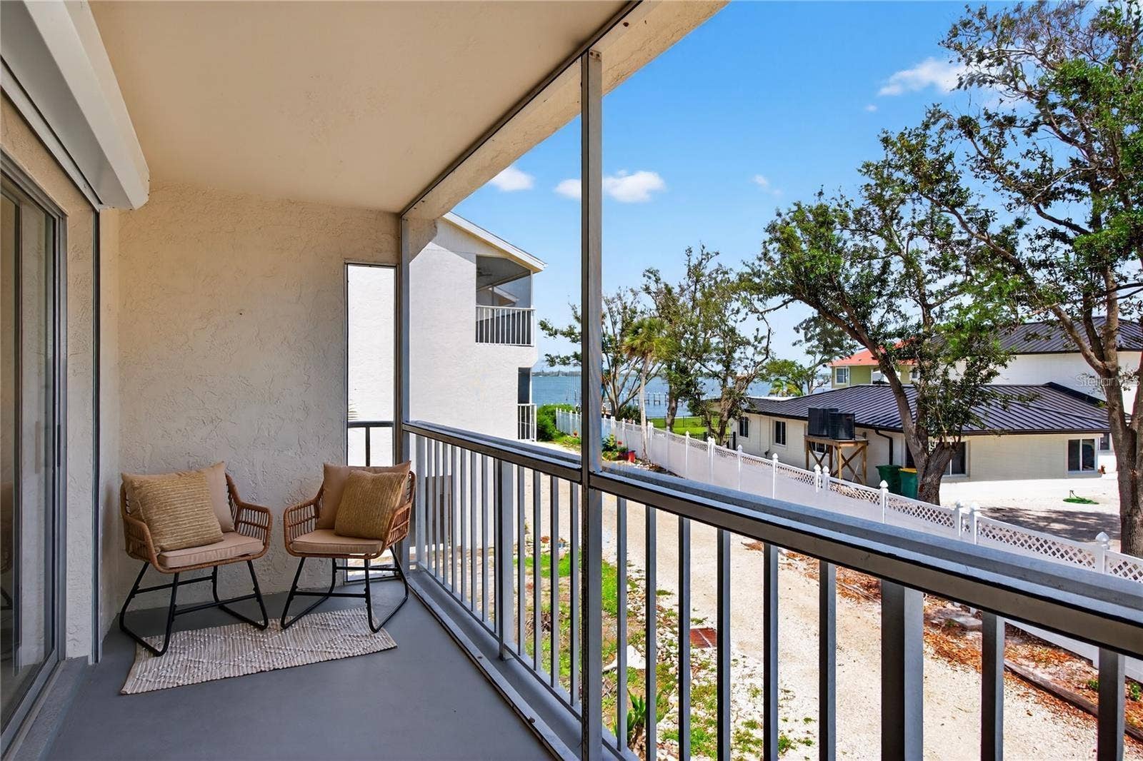 5031 N BEACH ROAD, #118, Englewood, FL 34223 Lanai Directly Off of Living Room and Primary Bedroom with Peekaboo Views to Lemon Bay