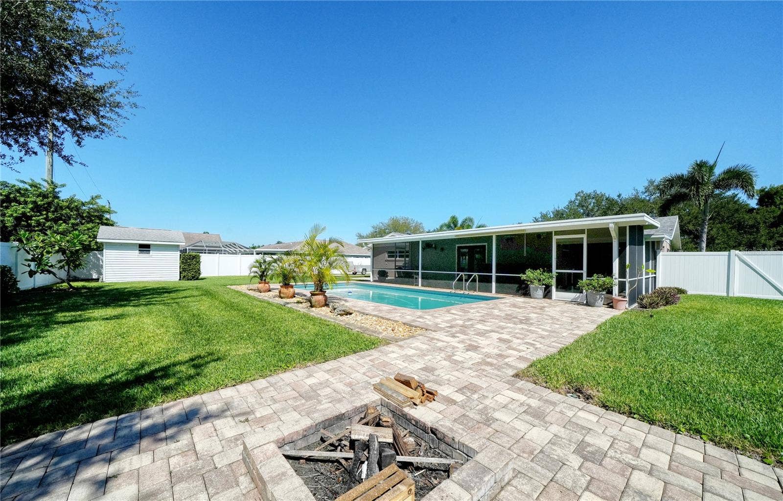 2304 50TH STREET W, Bradenton, FL 34209 Firepit toward pool & Florida Room