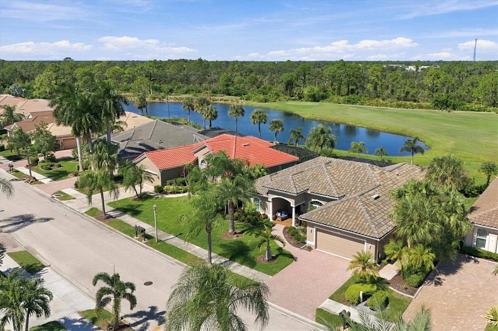 5496 WHITE IBIS DRIVE, North Port, FL 34287 Note lovely covered entry and handsome pavered driveway and walkway. Lake and fairway views of #2 of the Creek Course. Tile roof new 3/2024