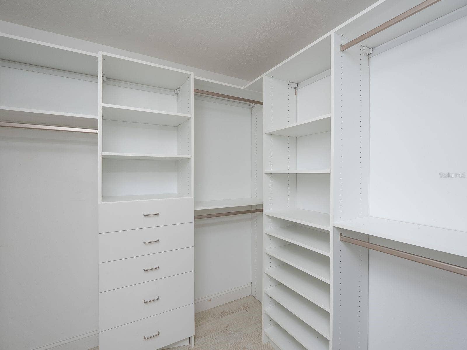 primary walk in closet with built in organizers