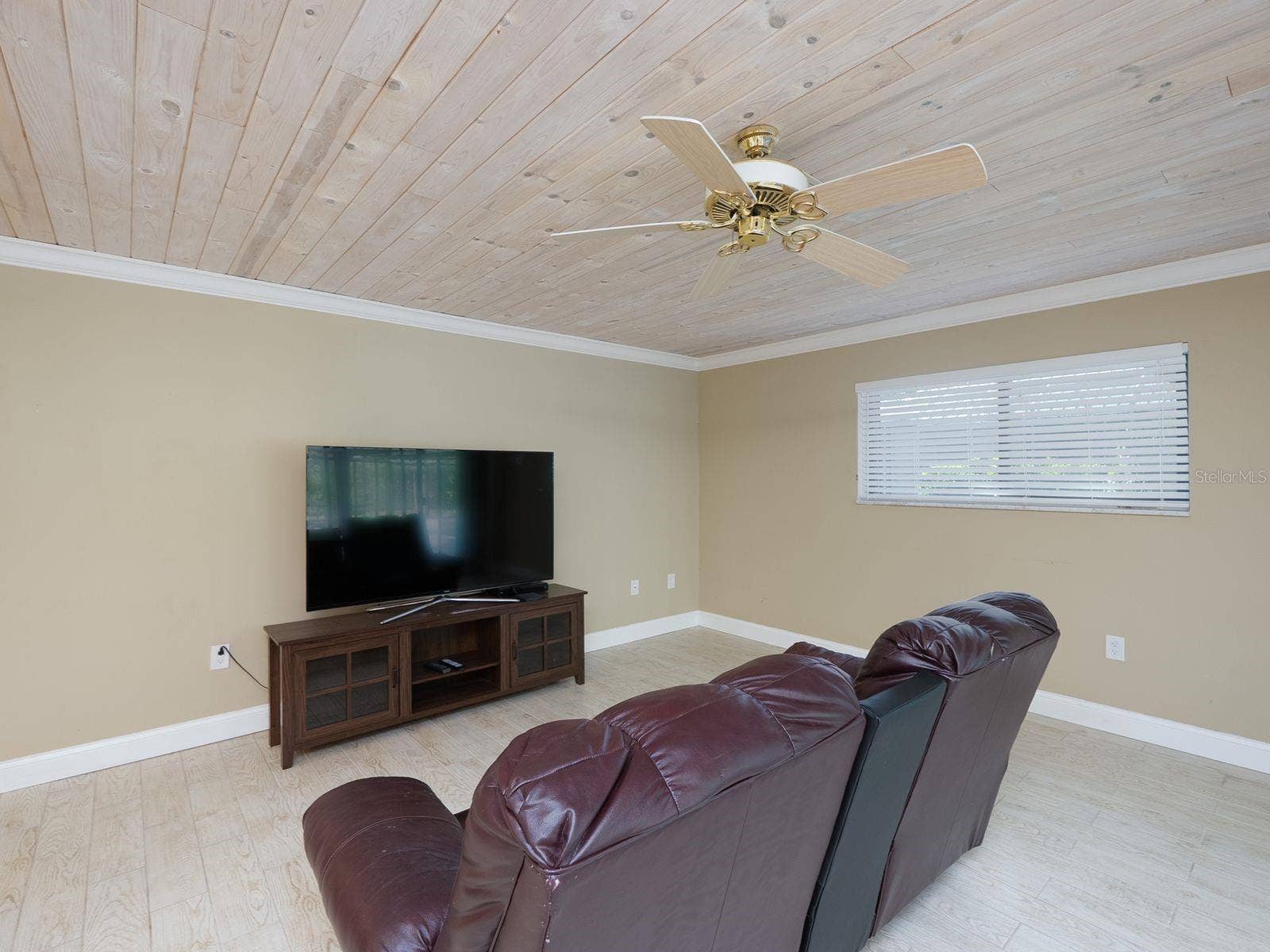family room with tongue and groove ceiling