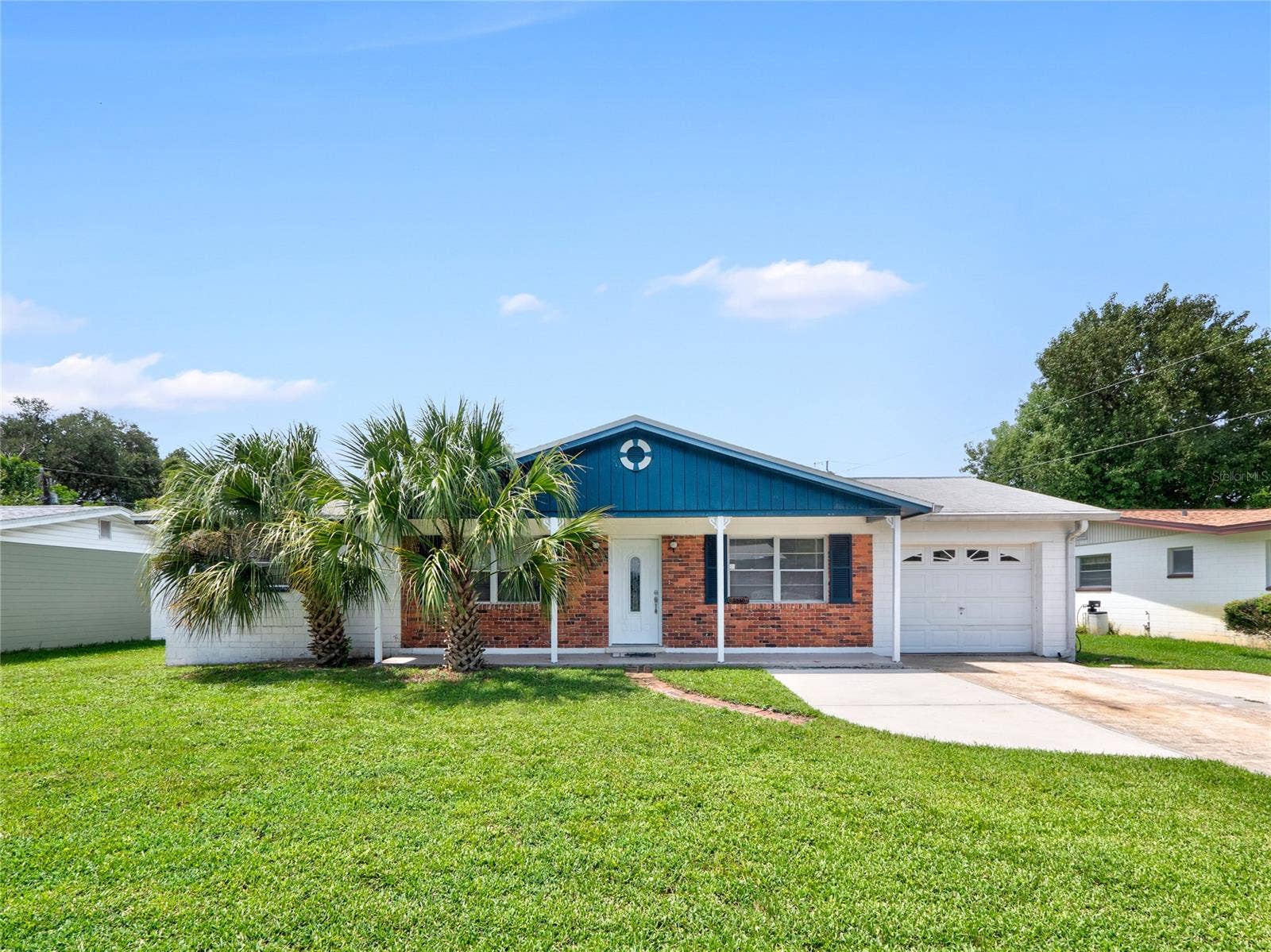 South Daytona, FL 32119 Solid concrete block home with 1-car garage + extended parking pad
