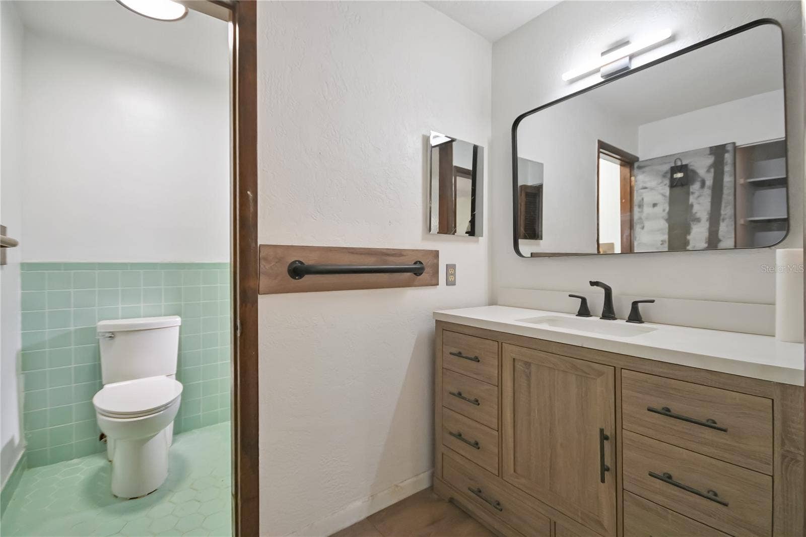 5820 RIVERSIDE DRIVE, Port Orange, FL 32127 Primary Bathroom with newer vanity and mirror.