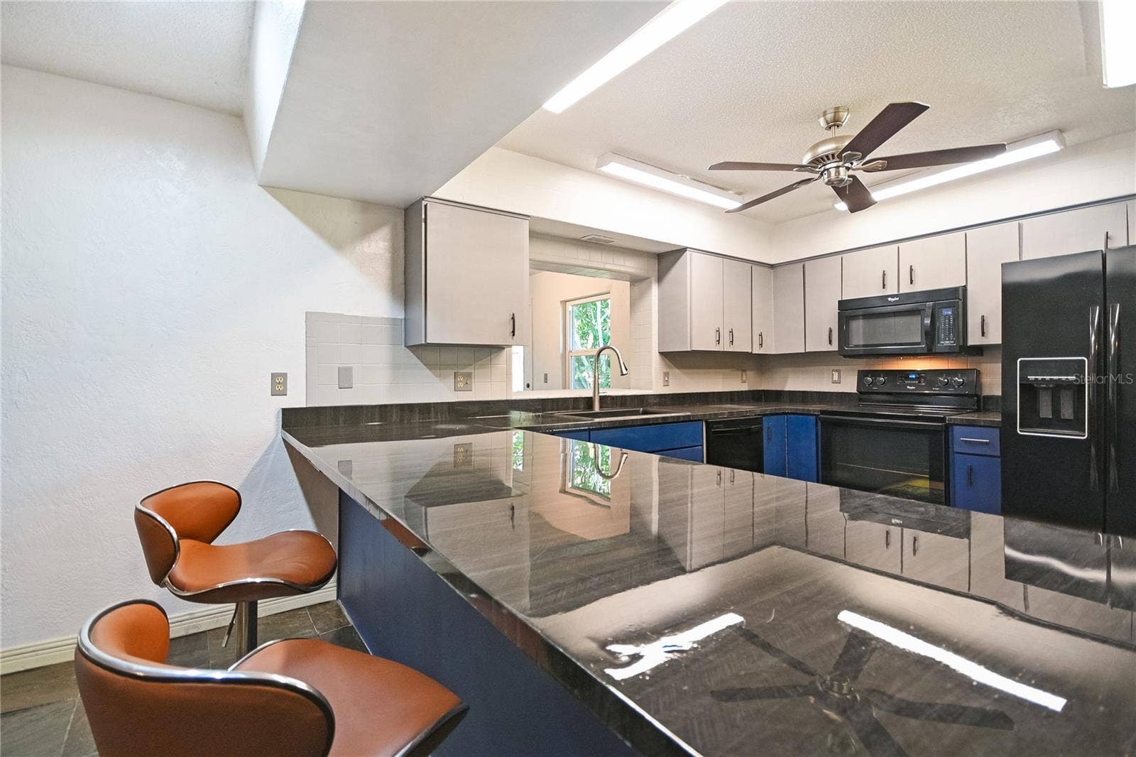 5820 RIVERSIDE DRIVE, Port Orange, FL 32127 Large kitchen bar is perfect for entertaining.