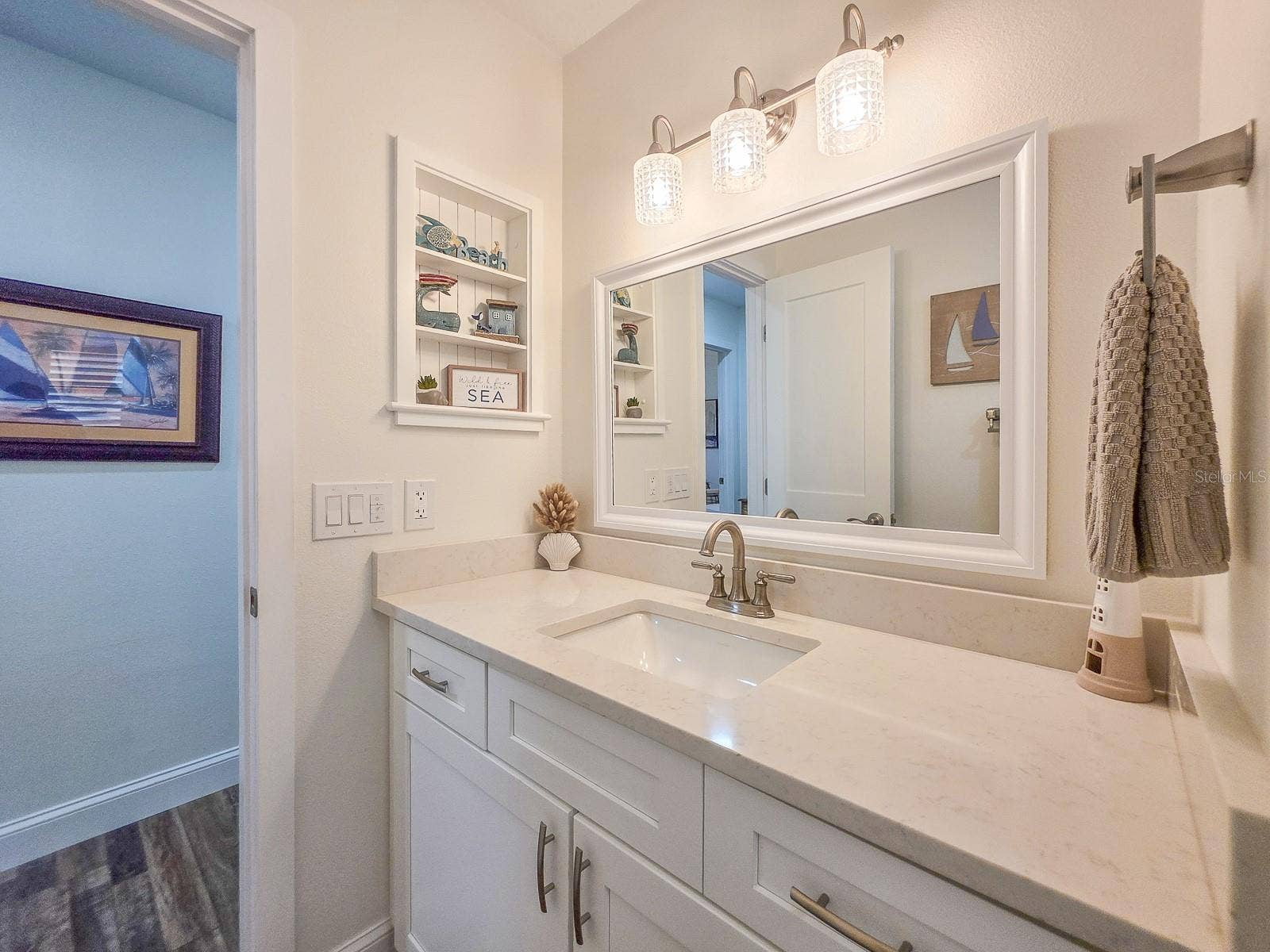 Beautiful quartz counters and built-in coastal curio shelf