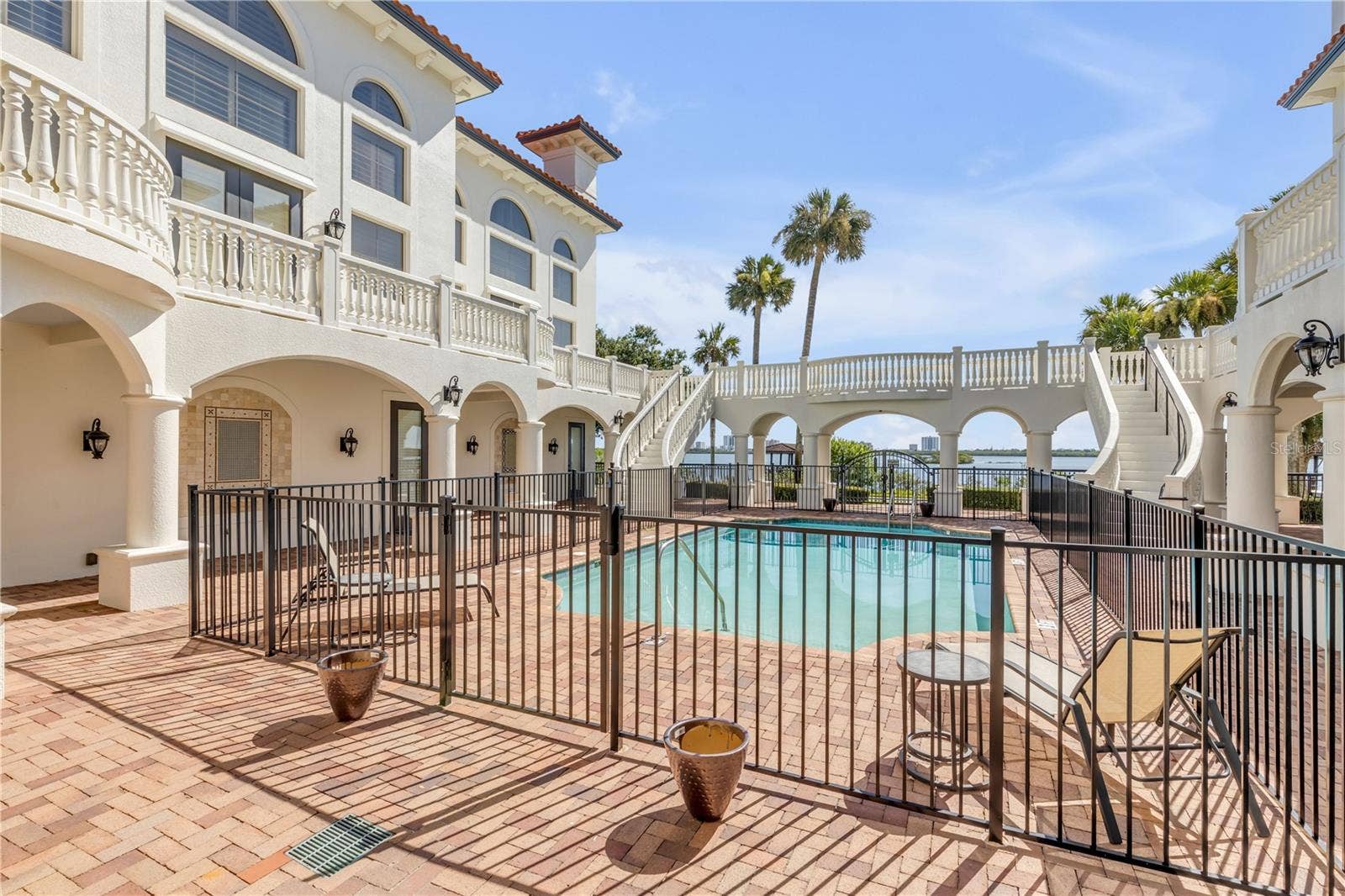5090 RIVERSIDE DRIVE, #105, Port Orange, FL 32127 Common Balcony with dual curved staircases coming toward the pool area.