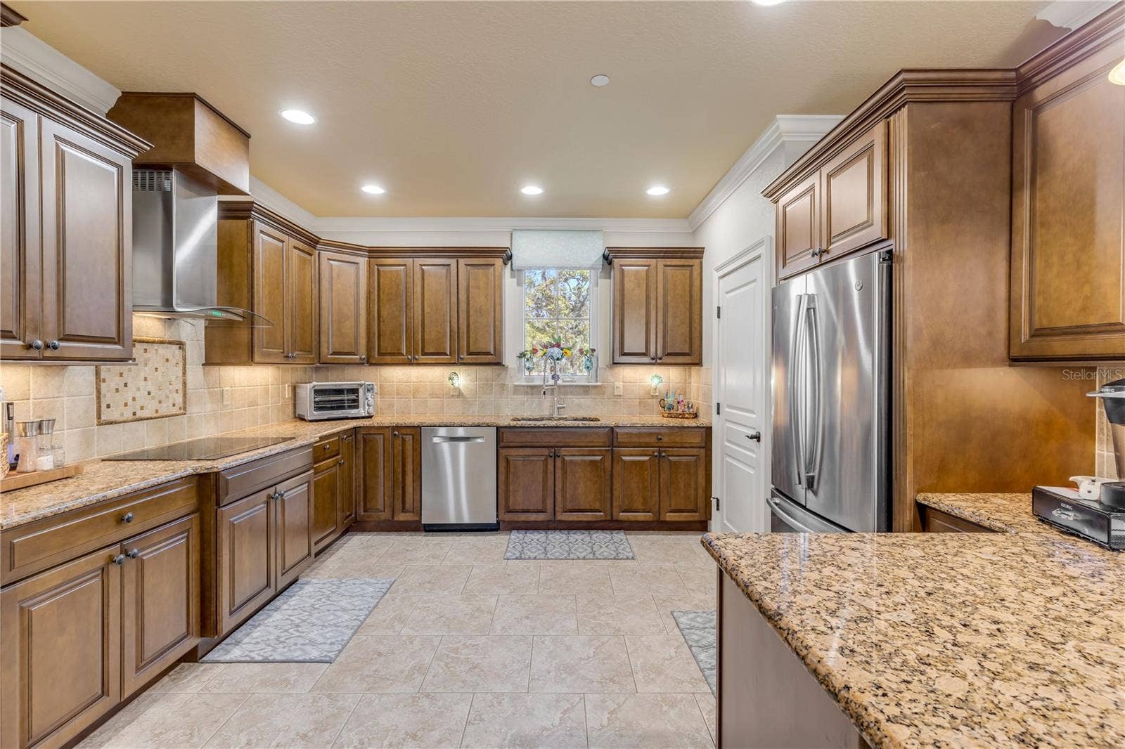 5090 RIVERSIDE DRIVE, #105, Port Orange, FL 32127 wood cabinets, granite countertops, tile backsplash