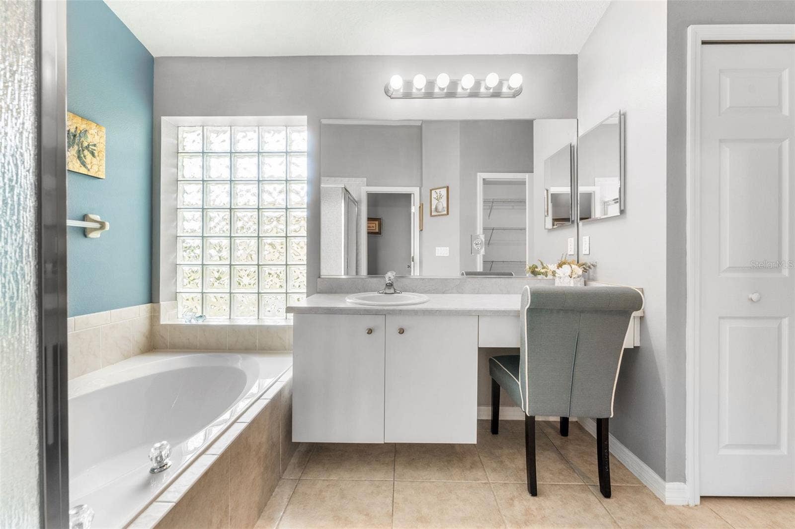 En Suite w/ vanity and linen closet.