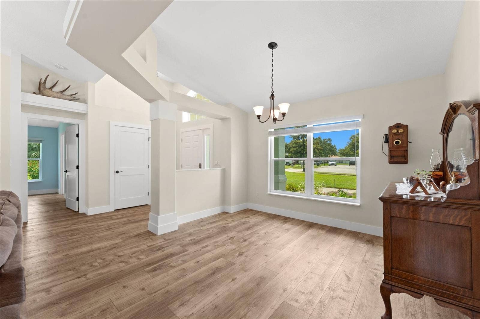 Views of dining room, foyer and entry to primary wing.
