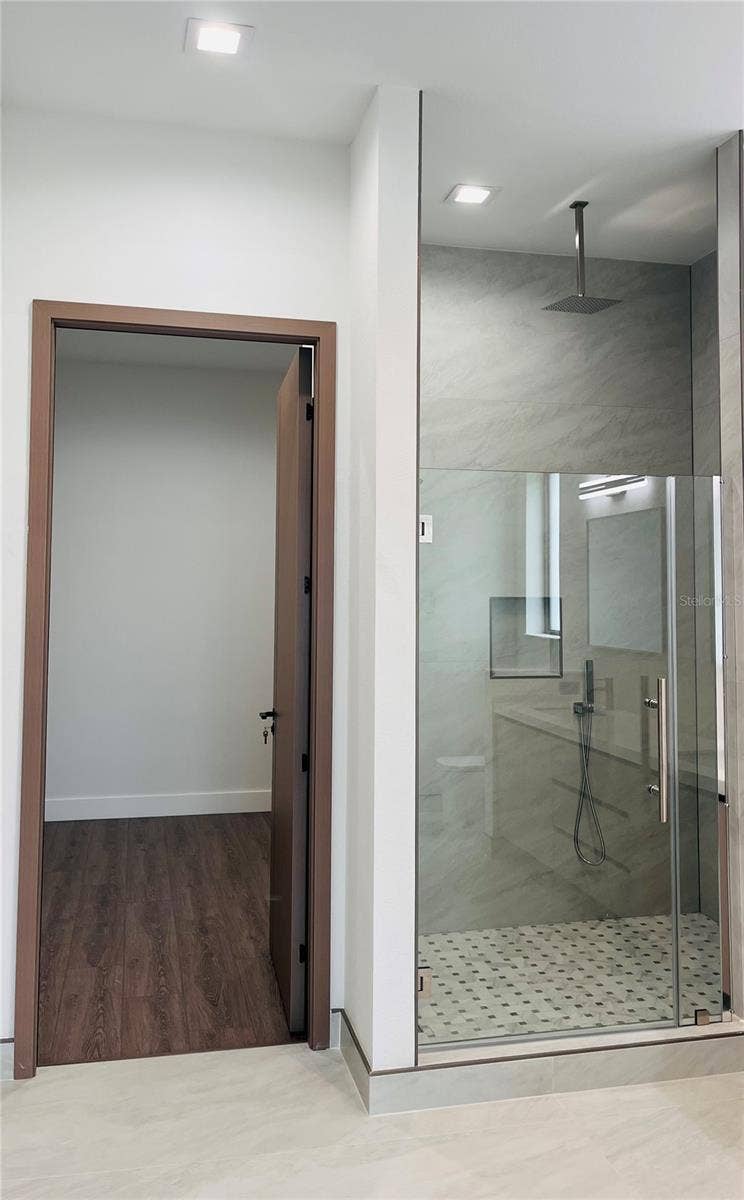 2115 N HALIFAX AVENUE, Daytona Beach, FL 32118 PRIMARY ENSUITE BATHROOM SHOWER W/HER WALK-IN CLOSET