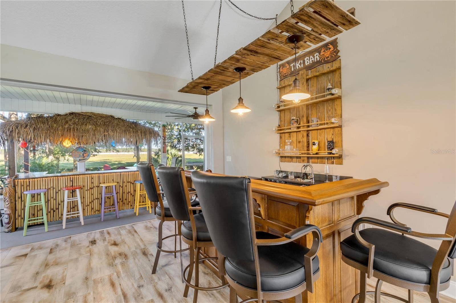 630 HAMMETT LANE, New Smyrna Beach, FL 32168 bar area leading to the lanai