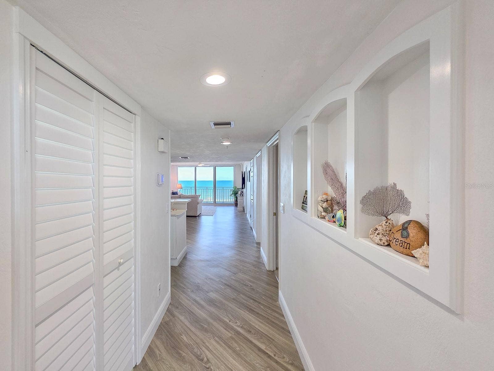 2545 S ATLANTIC AVENUE, #403, Daytona Beach Shores, FL 32118 Hallway with laundry on left and built-ins on left.