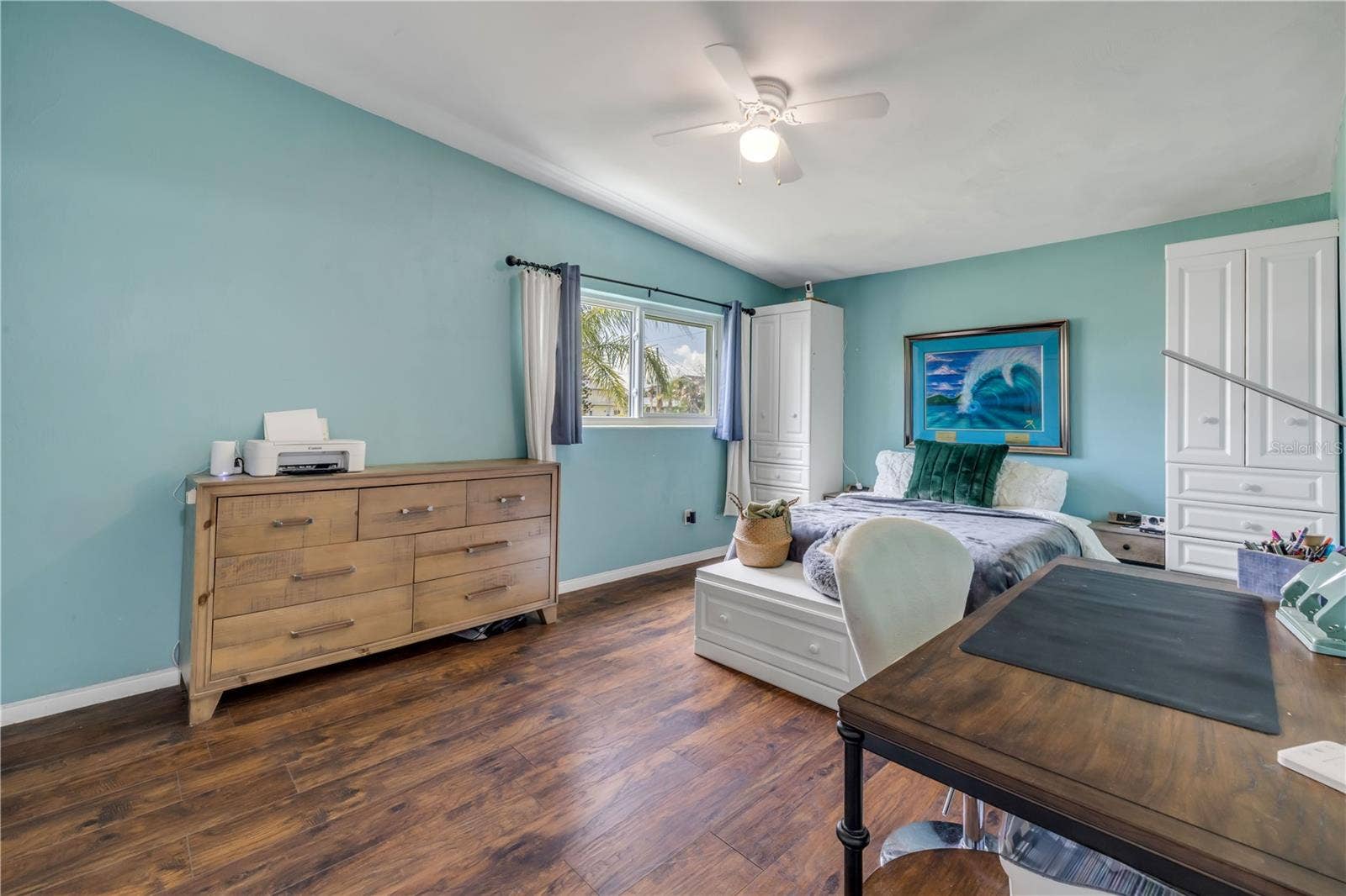 3929 S PENINSULA DRIVE, Port Orange, FL 32127 Bedroom with windows, ceiling fan and coastal-blue walls.