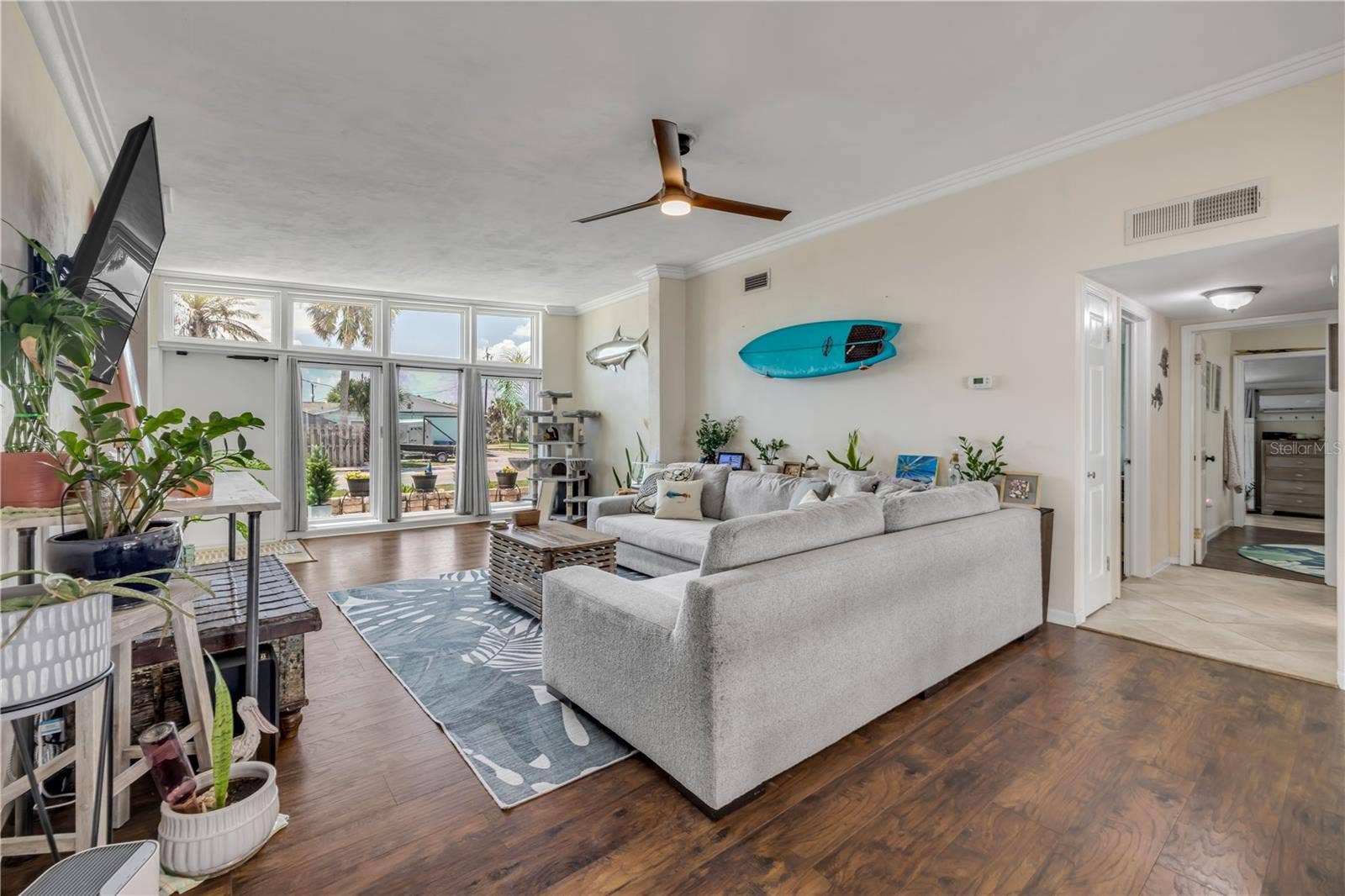 3929 S PENINSULA DRIVE, Port Orange, FL 32127 Living area with wood flooring and views toward the front windows.