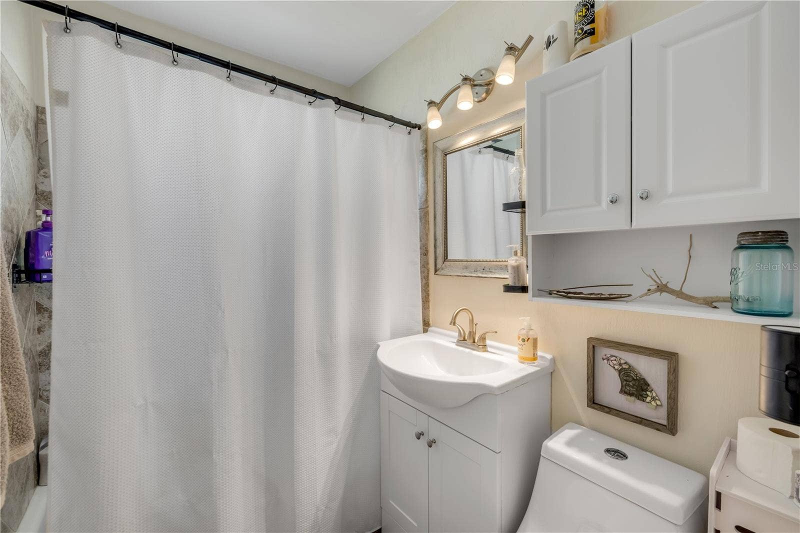 3929 S PENINSULA DRIVE, Port Orange, FL 32127 Bathroom with a vanity and tub/shower combination.