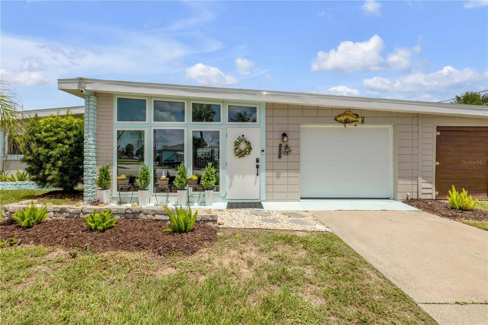3929 S PENINSULA DRIVE, Port Orange, FL 32127 Front entry with enclosed porch and attached garage.