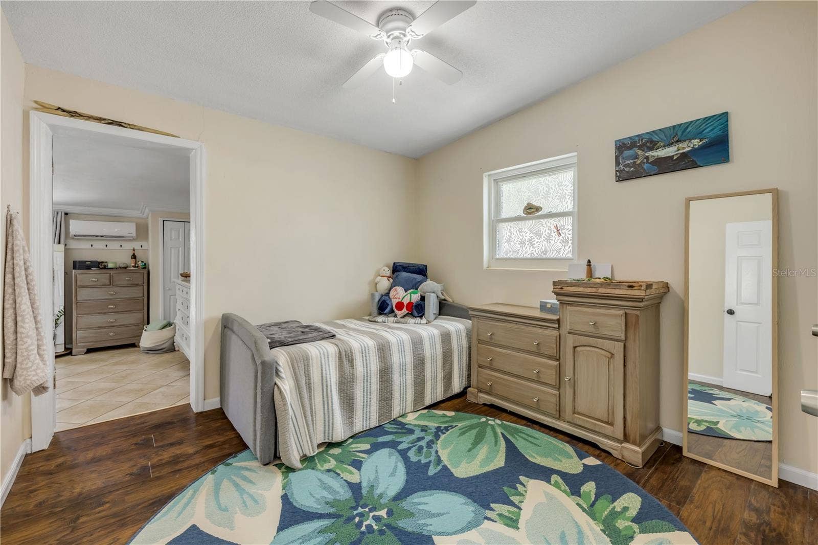 3929 S PENINSULA DRIVE, Port Orange, FL 32127 Bedroom with wood flooring and a ceiling fan.