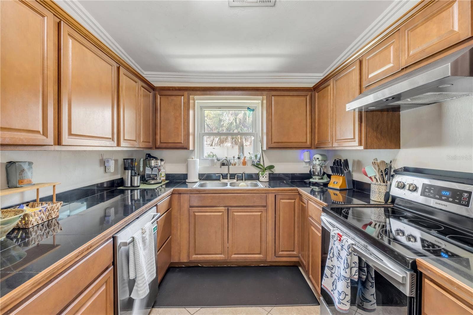 3929 S PENINSULA DRIVE, Port Orange, FL 32127 Kitchen view highlighting cabinet storage and counter space.